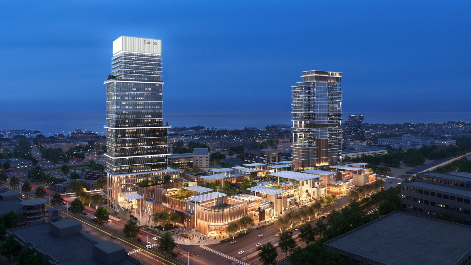 Aerial view at dusk featuring activated retail podiums, integrated public realm, and illuminated high-rise towers designed around pedestrian activity and connectivity.