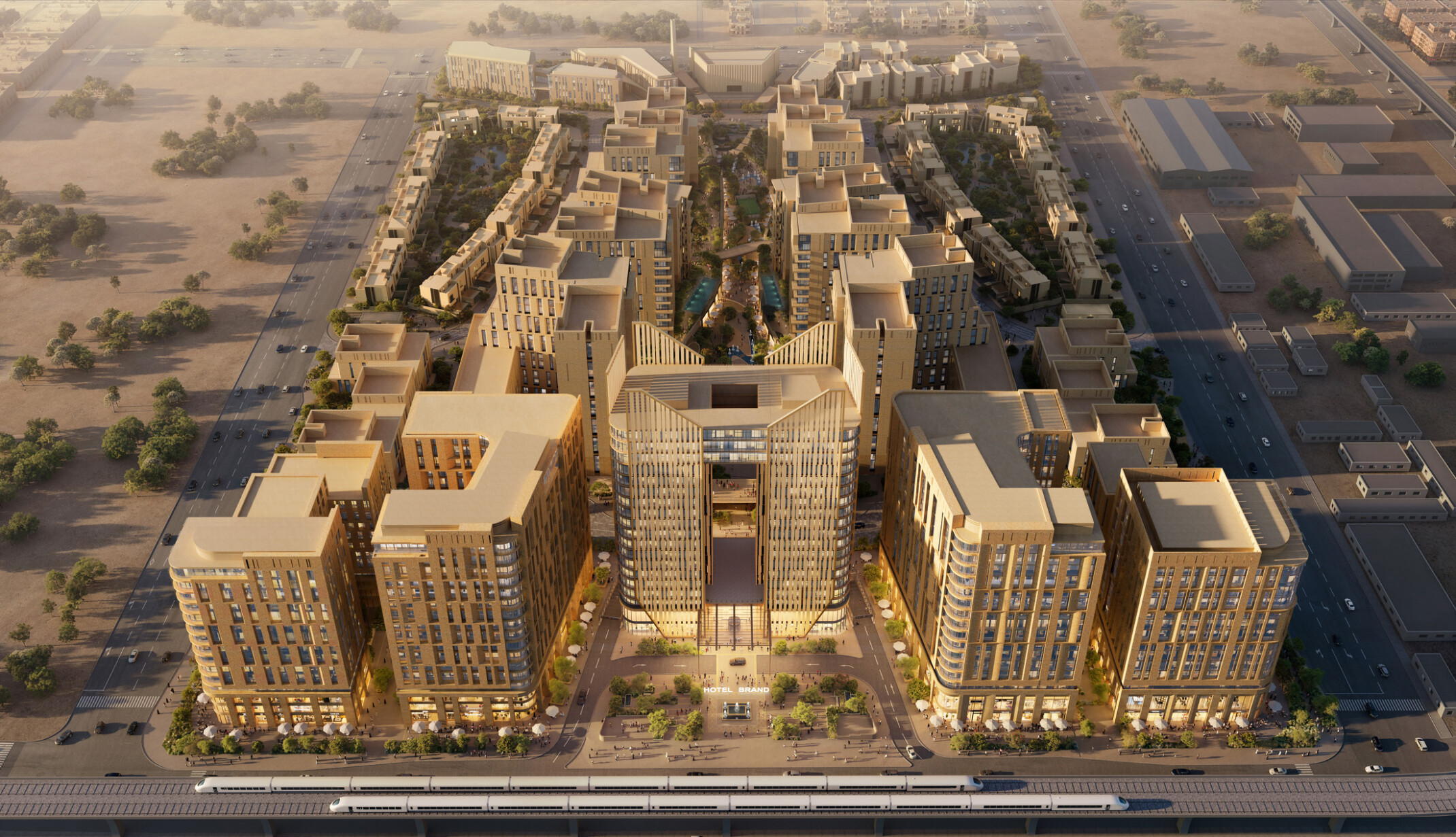 Aerial view of LIWAN Najd in Riyadh, showing mixed-use buildings arranged around a central landscaped wadi, with residential towers, active ground floors, and surrounding streets.