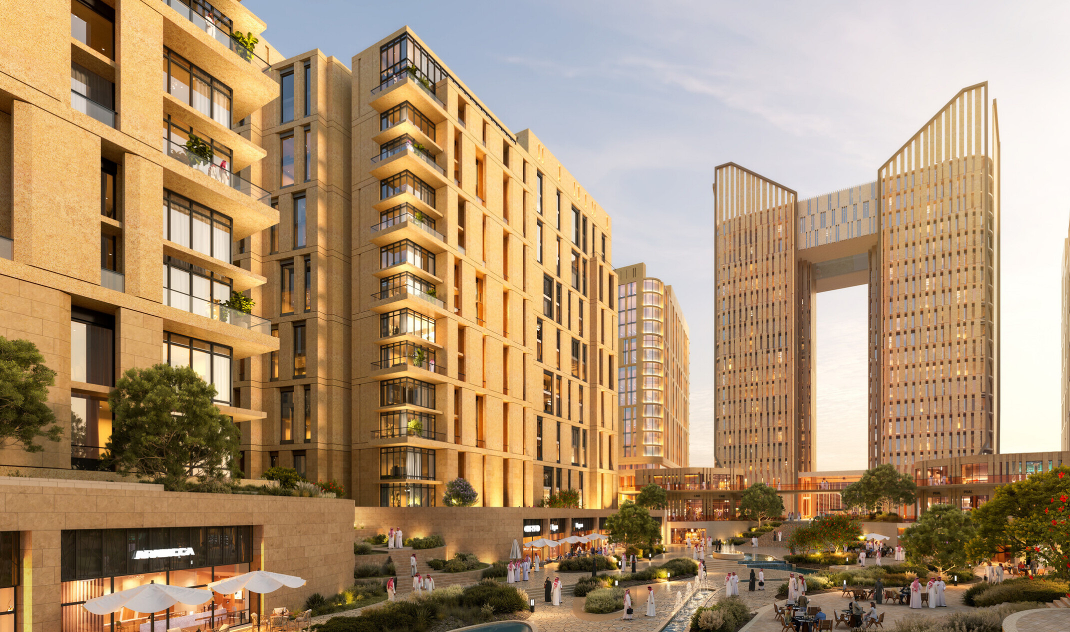 Street-level view of LIWAN Najd in Riyadh, showing residential towers, the hotel, active ground-floor retail, and a pedestrian-focused public realm.