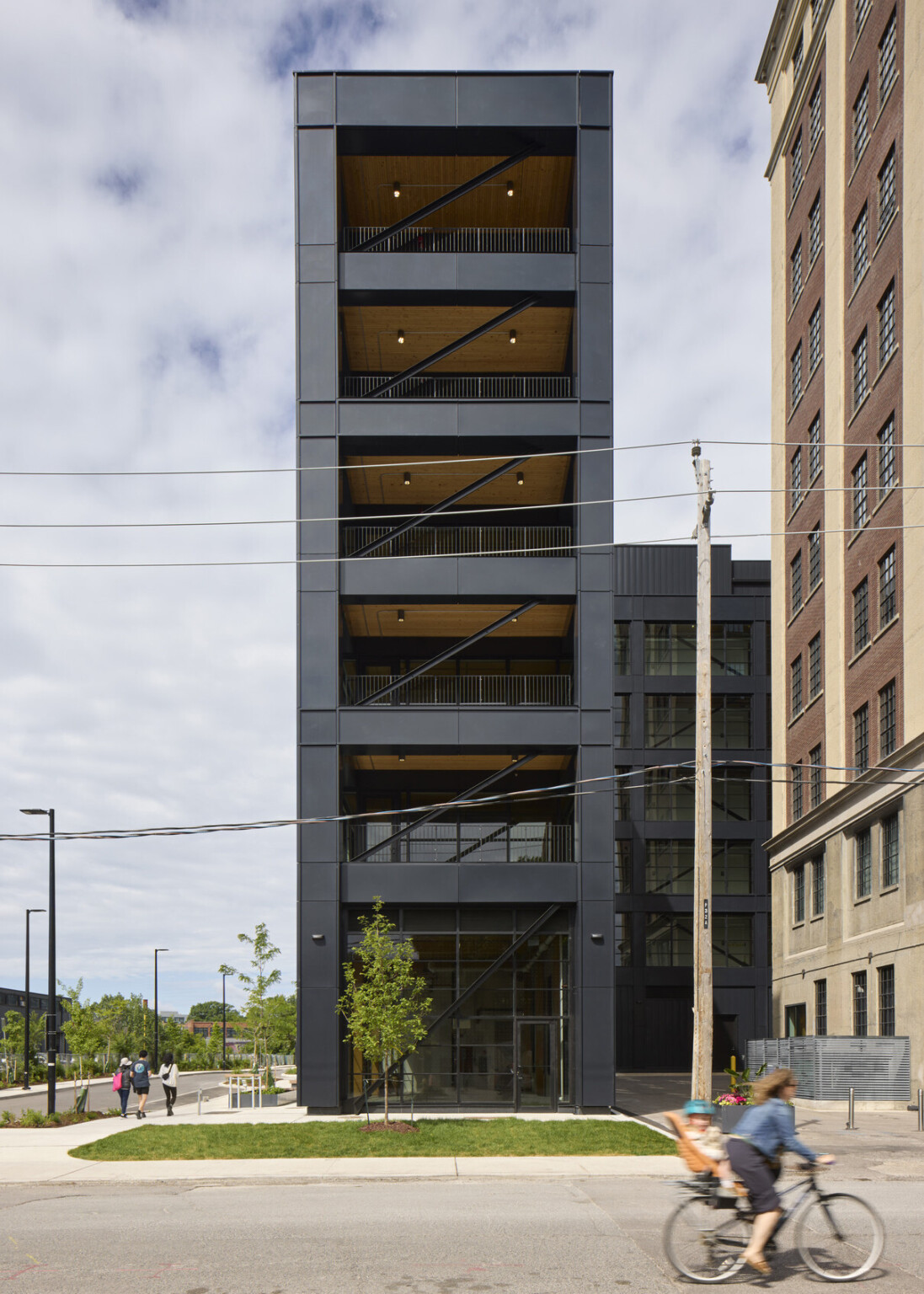 Tall narrow building showing balconies on each floor with metal railings