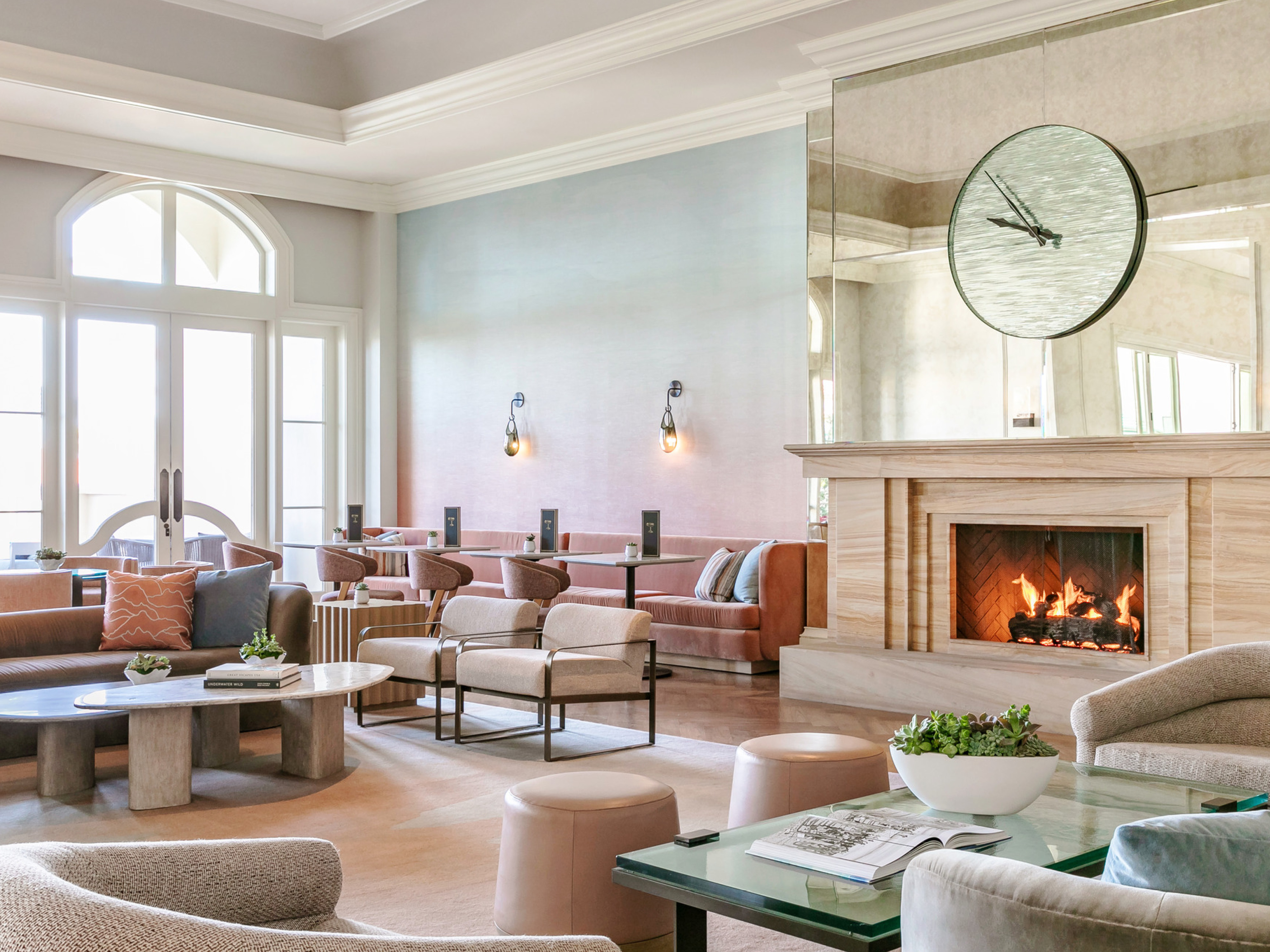 luxury interior of a hotel lobby, eating space; feature fireplace in the center of the room