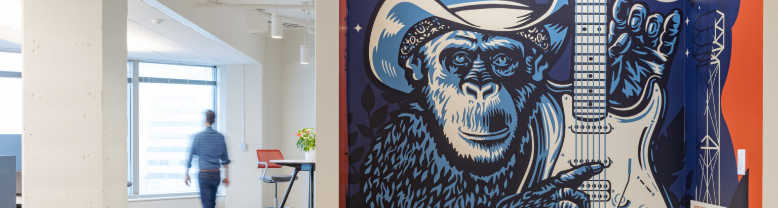 modern office hallway with mural of a guitar-playing monkey
