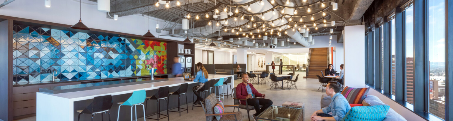 modern office with communal kitchen and counterspace along with couches and chairs; DLR Group LA office