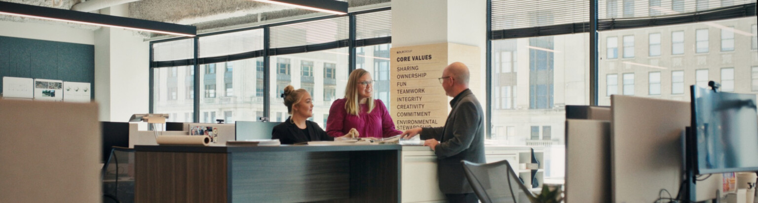 modern office collaboration hub with people talking; DLR Group Nashville office