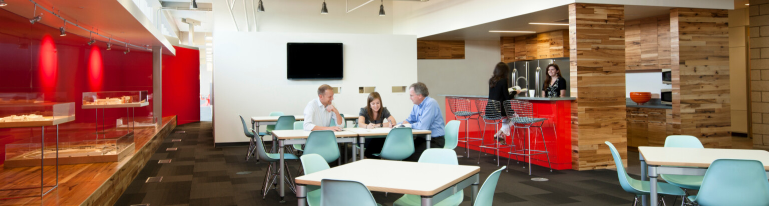 modern office collaboration zone with tables and high-top seating for eating and working; DLR Group Omaha office