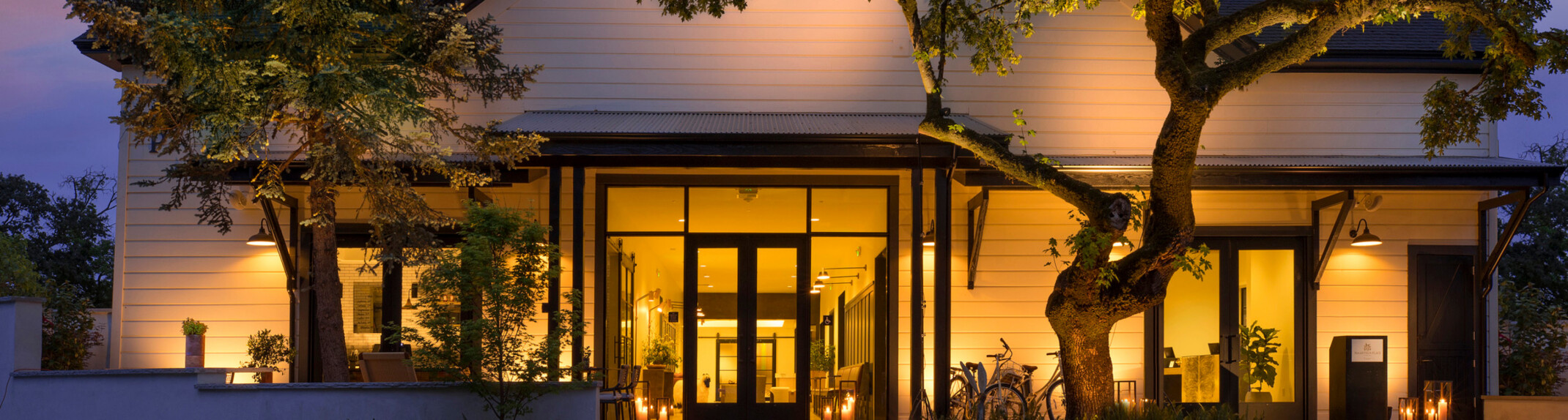 evening image of a cabin-like building front entrance