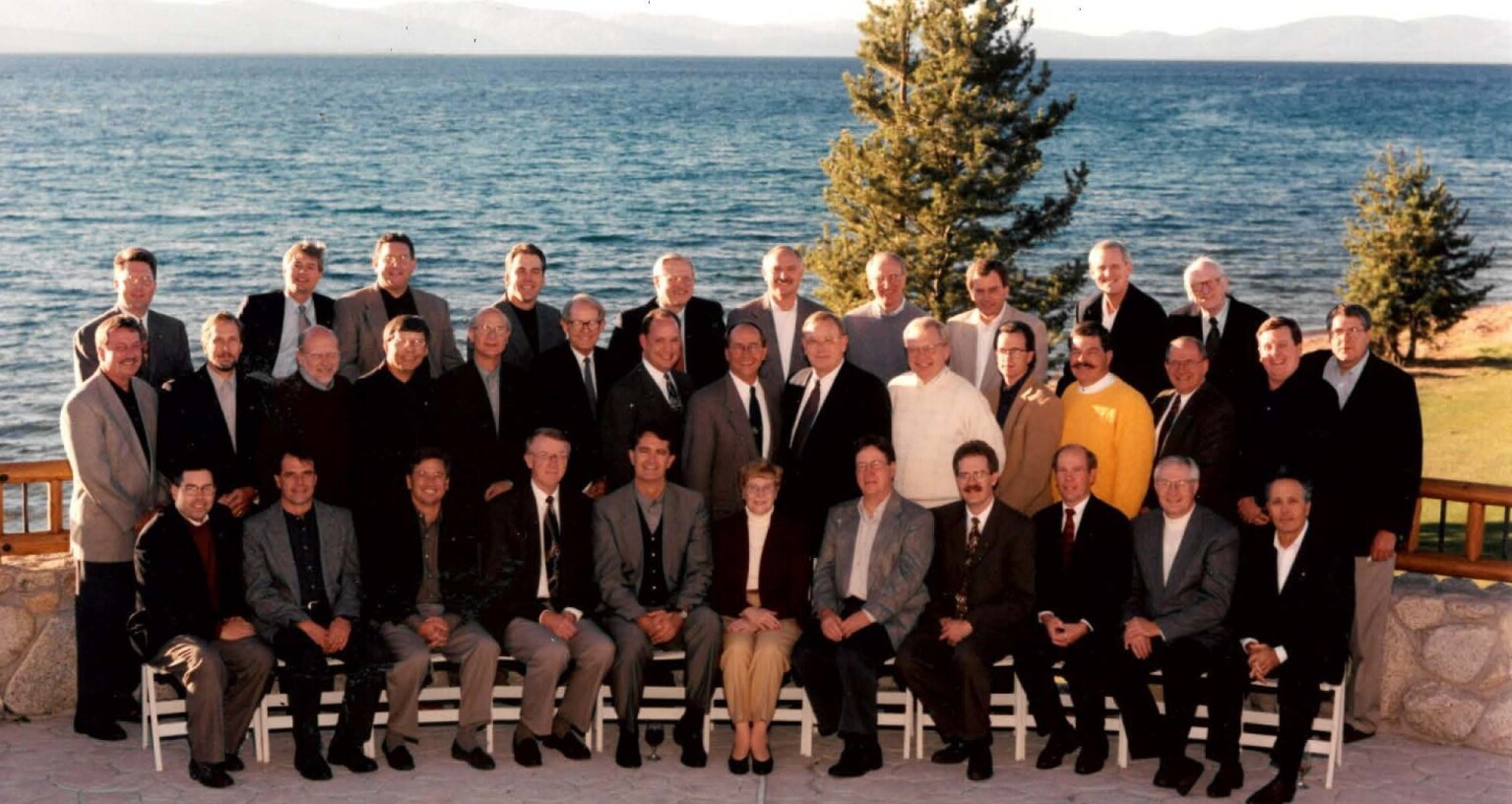 historic image of architects and engineers seated together with the first female employee at the firm