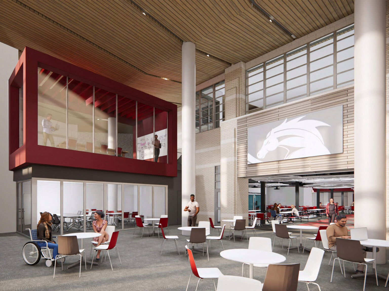 Interior of commons addition, double height space with large windows and red accent wall