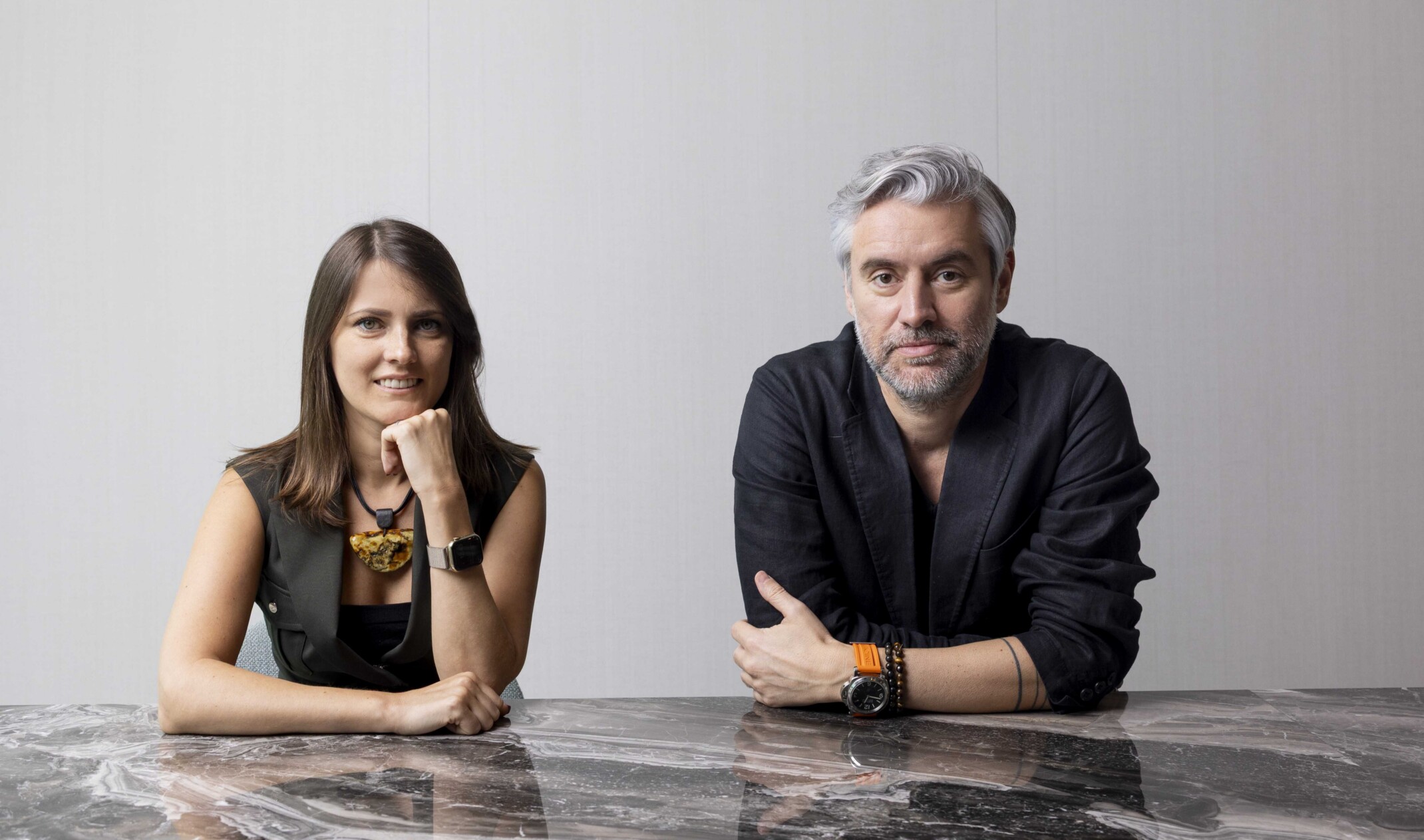 Henrique Dias and Vaida Buchrotaite sitting at a marble table