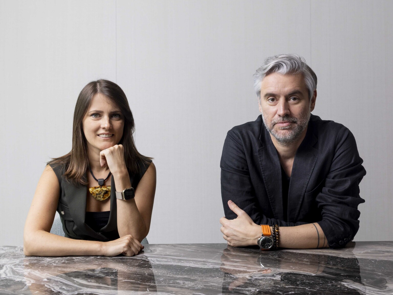 Henrique Dias and Vaida Buchrotaite sitting at a marble table