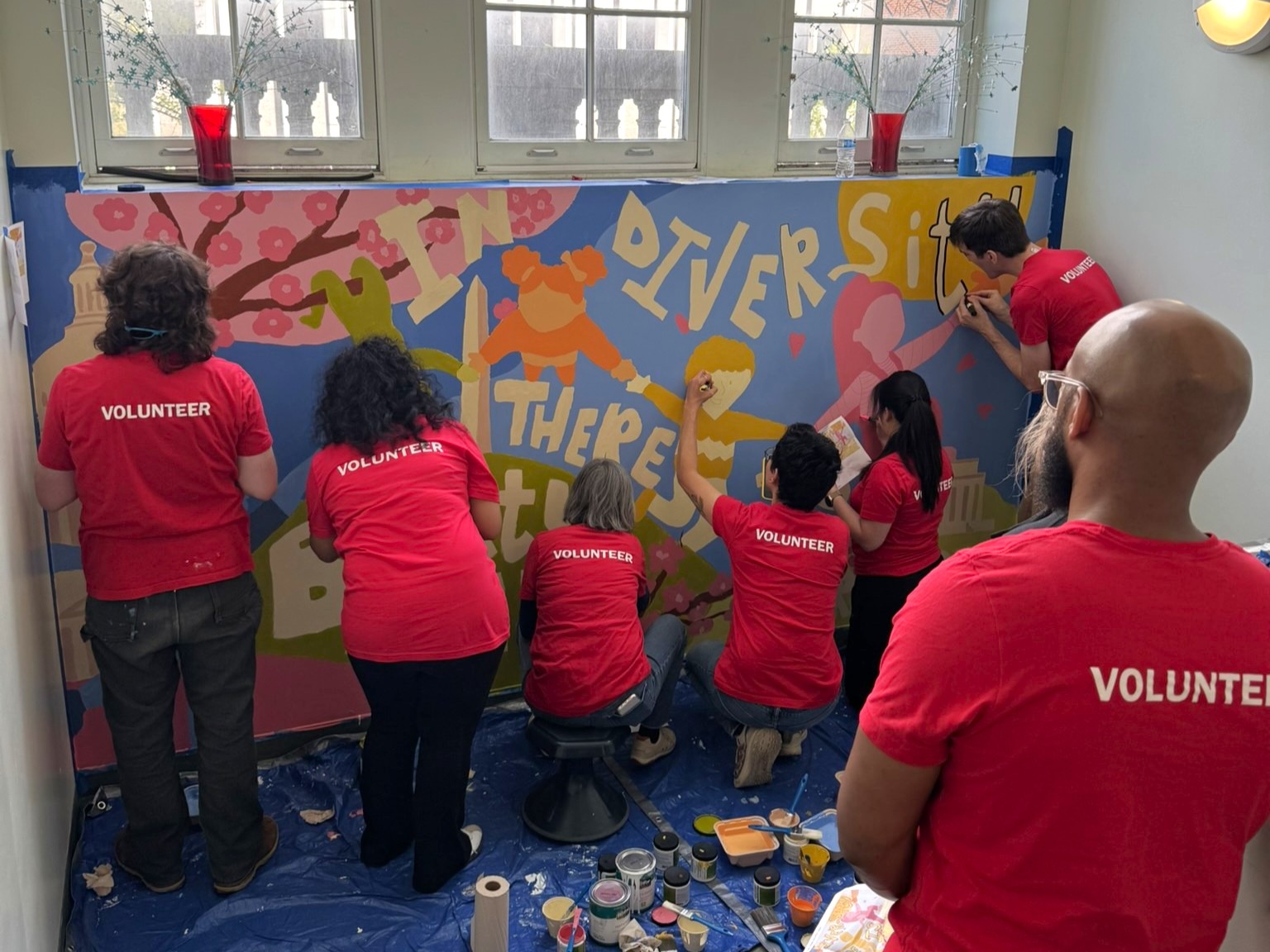 DLR Group employees painting mural
