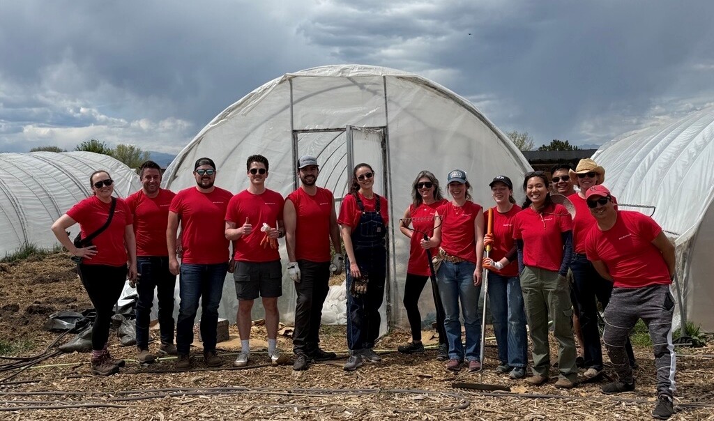 DLR Group employees standing in front of a greenhouse