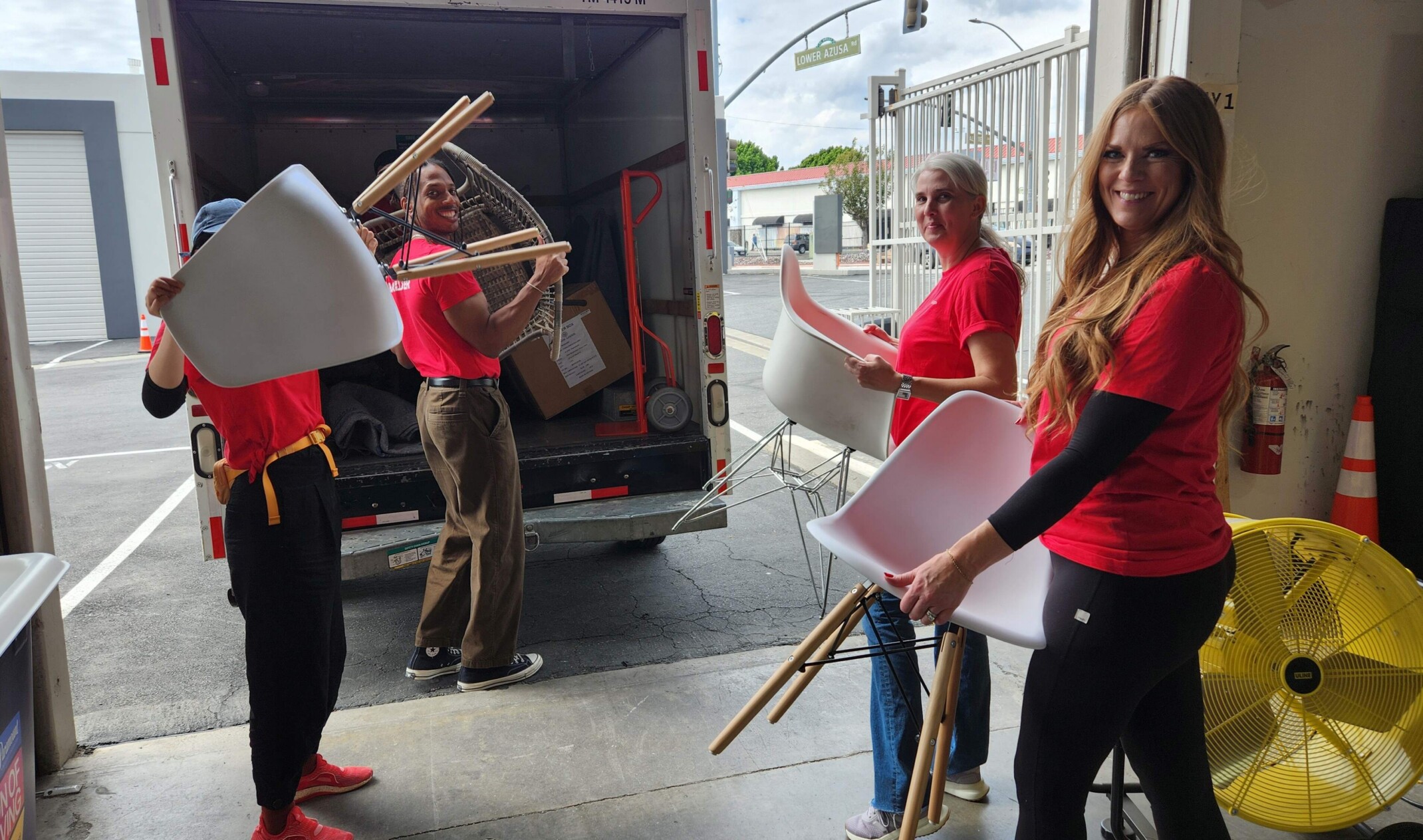 DLR Group employees loading furniture into the back of a truck