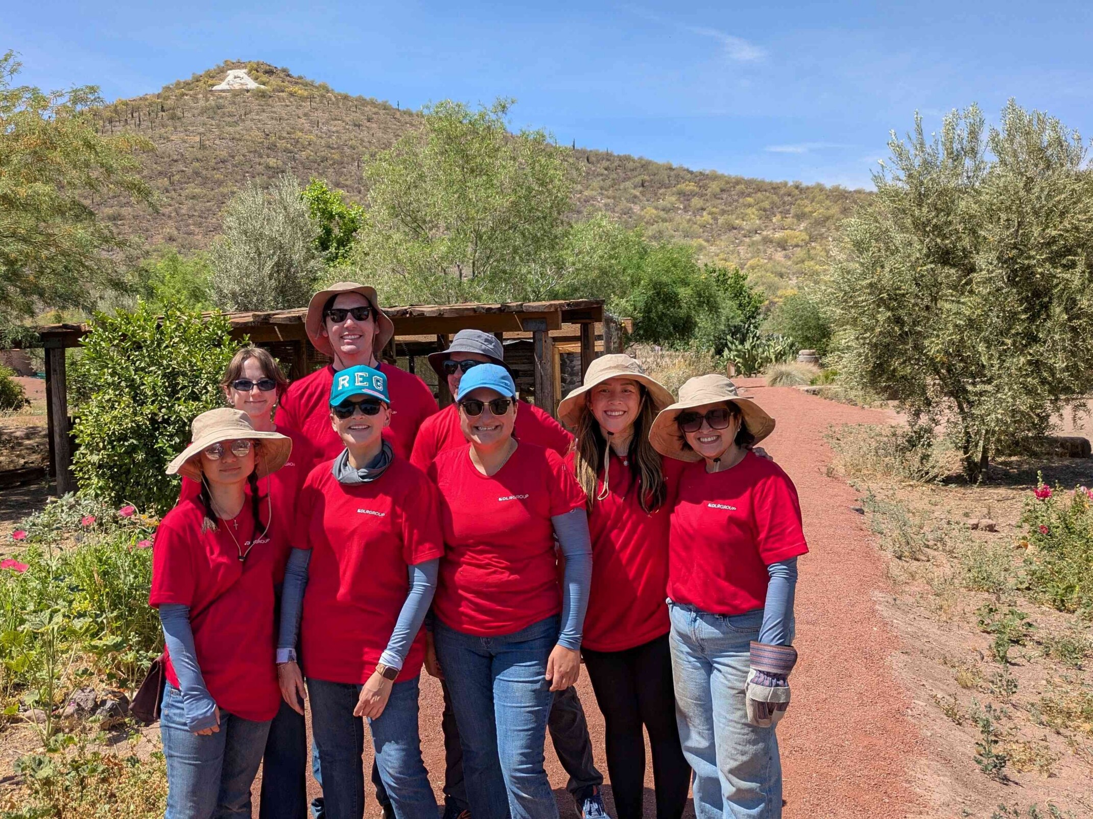 DLR Group employees standing in front of a desert greenspace