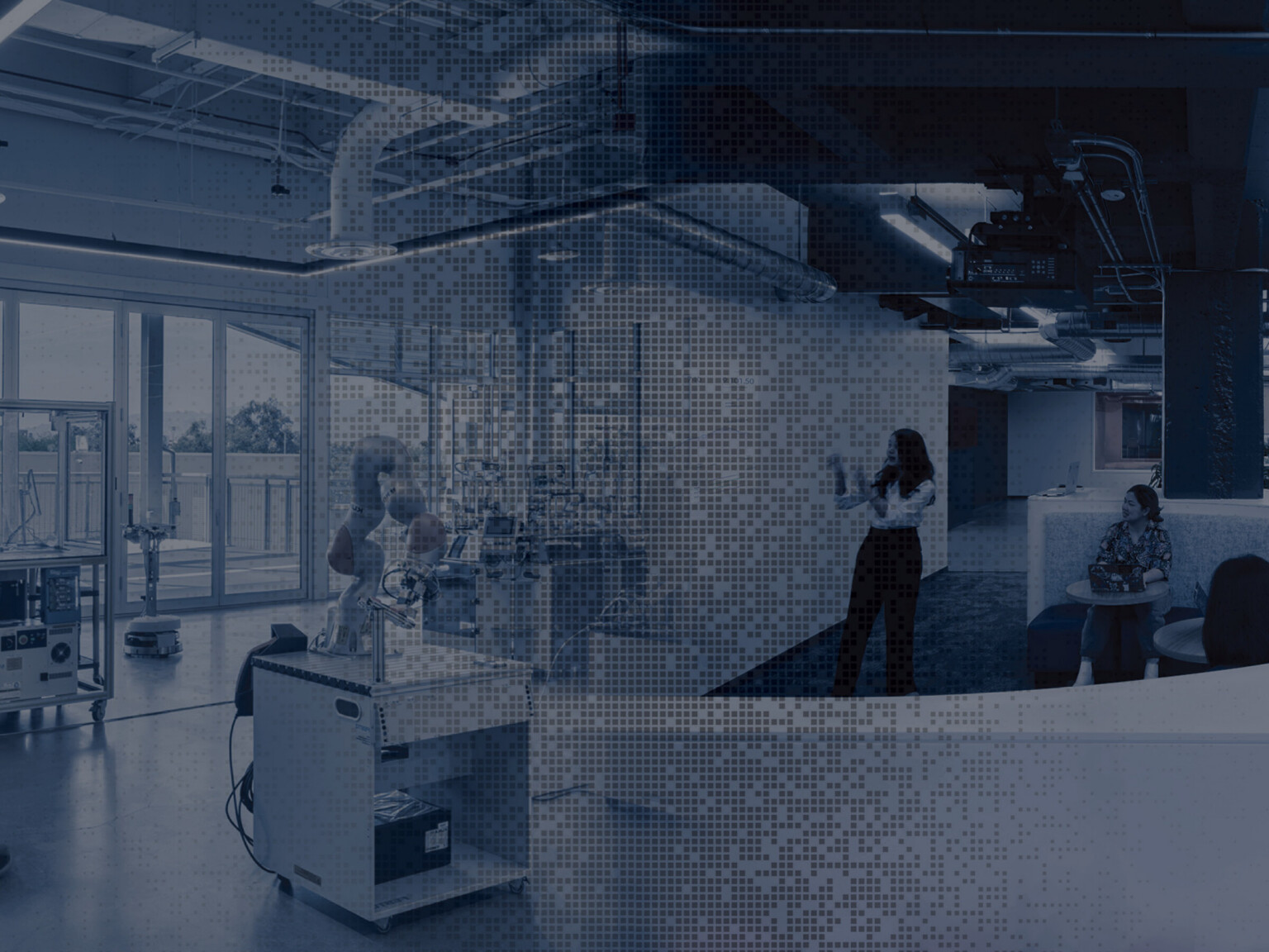 A composite-style image showing a laboratory workspace on the left, with equipment and people working near large windows, all overlaid with a blue pixelated pattern