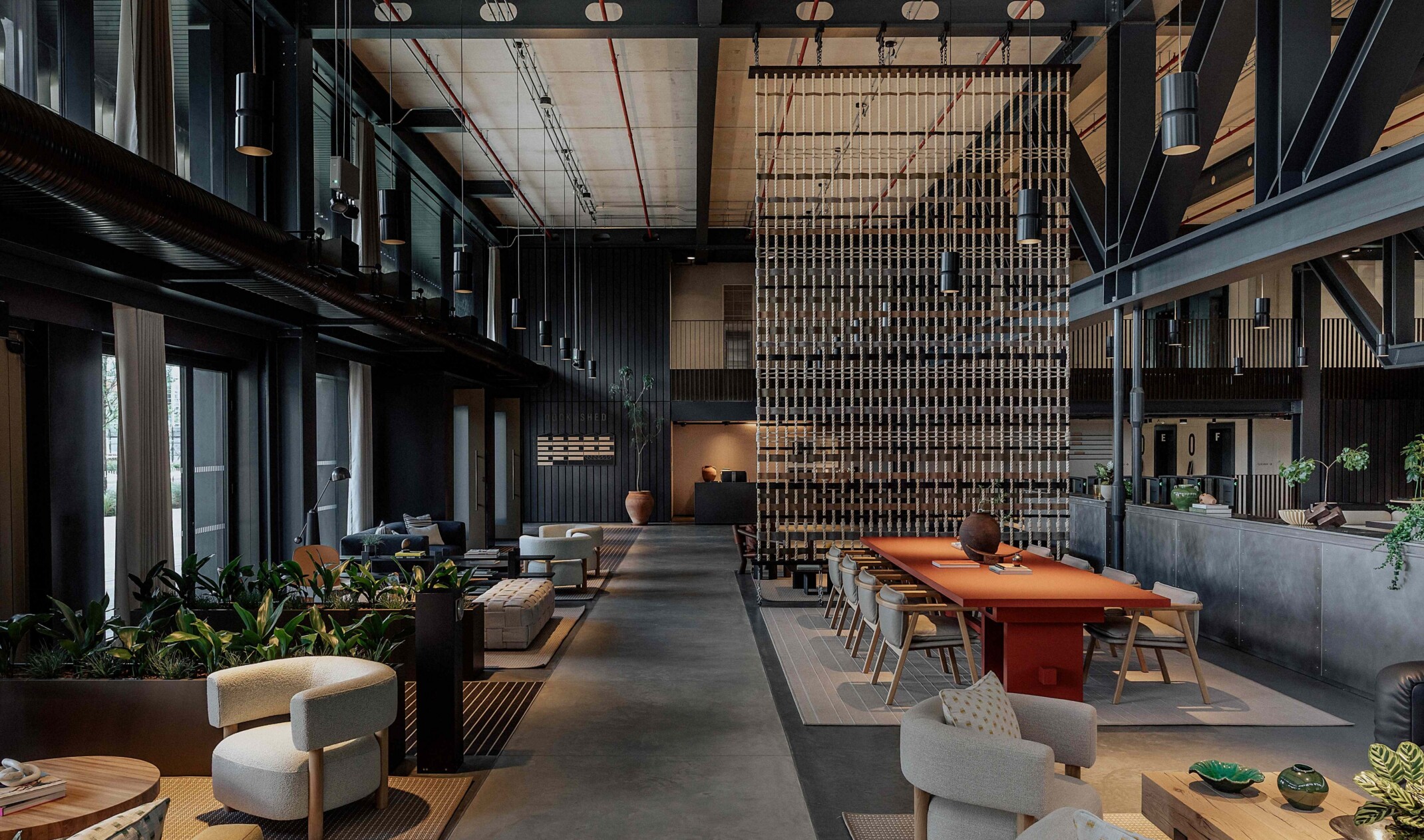 social and community hub with varied table and sofa seating in an elevated industrial yet luxurious space
