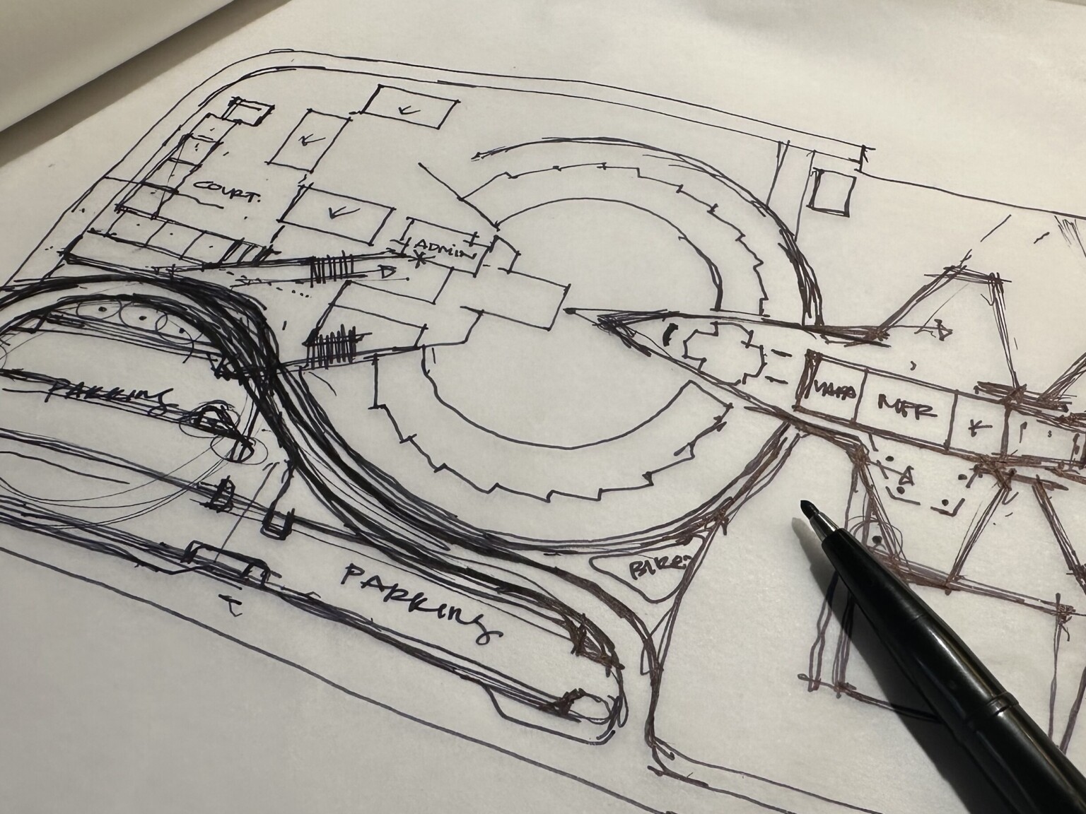 Design sketch on white paper with black lines with open marker to the side Design sketch on white paper with black lines with open marker to the side