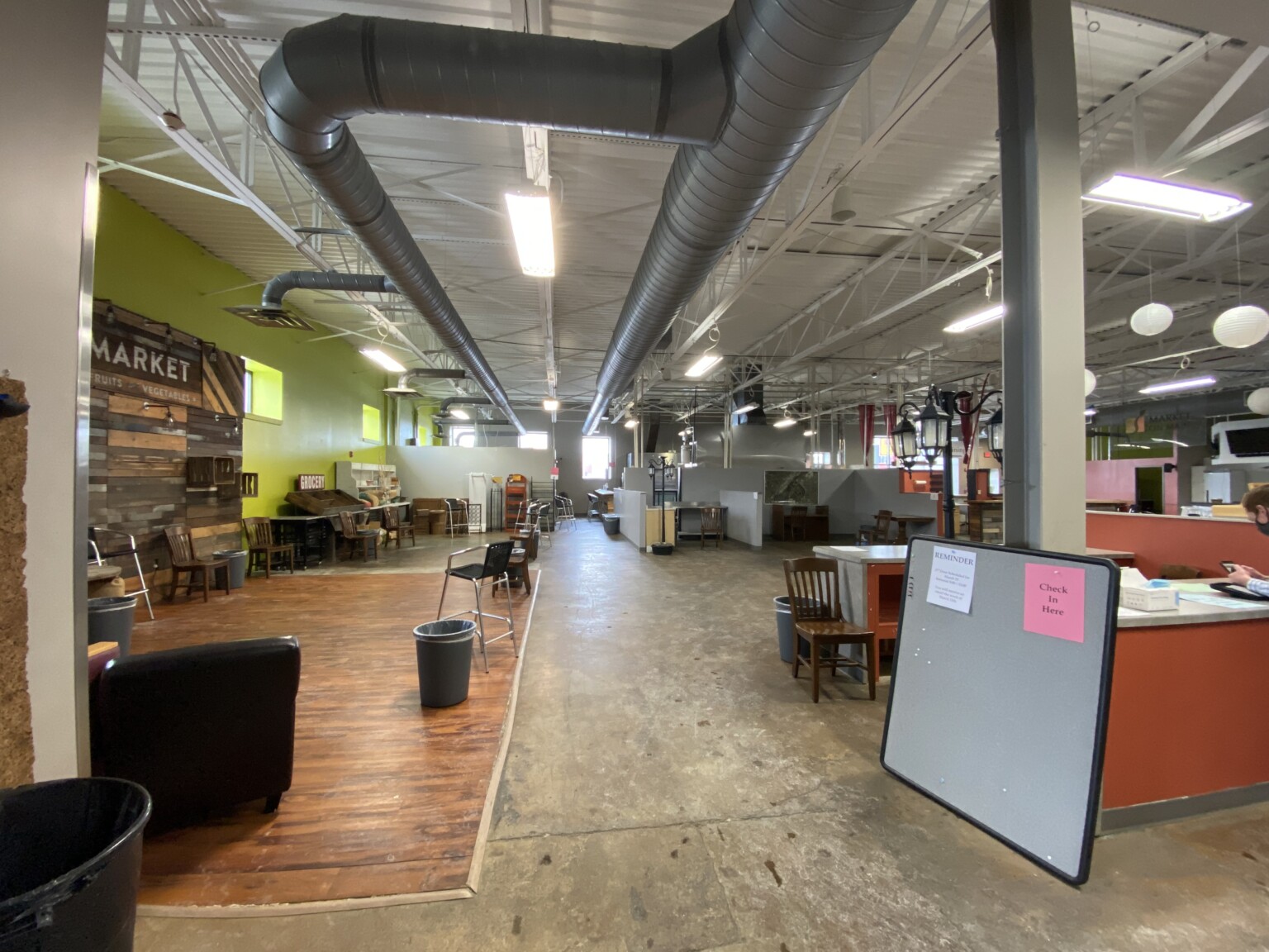 career reception area, hardwood flooring, polished concrete flooring, exposed ductwork, high-ceilings, lime green accent wall, low seating modules
