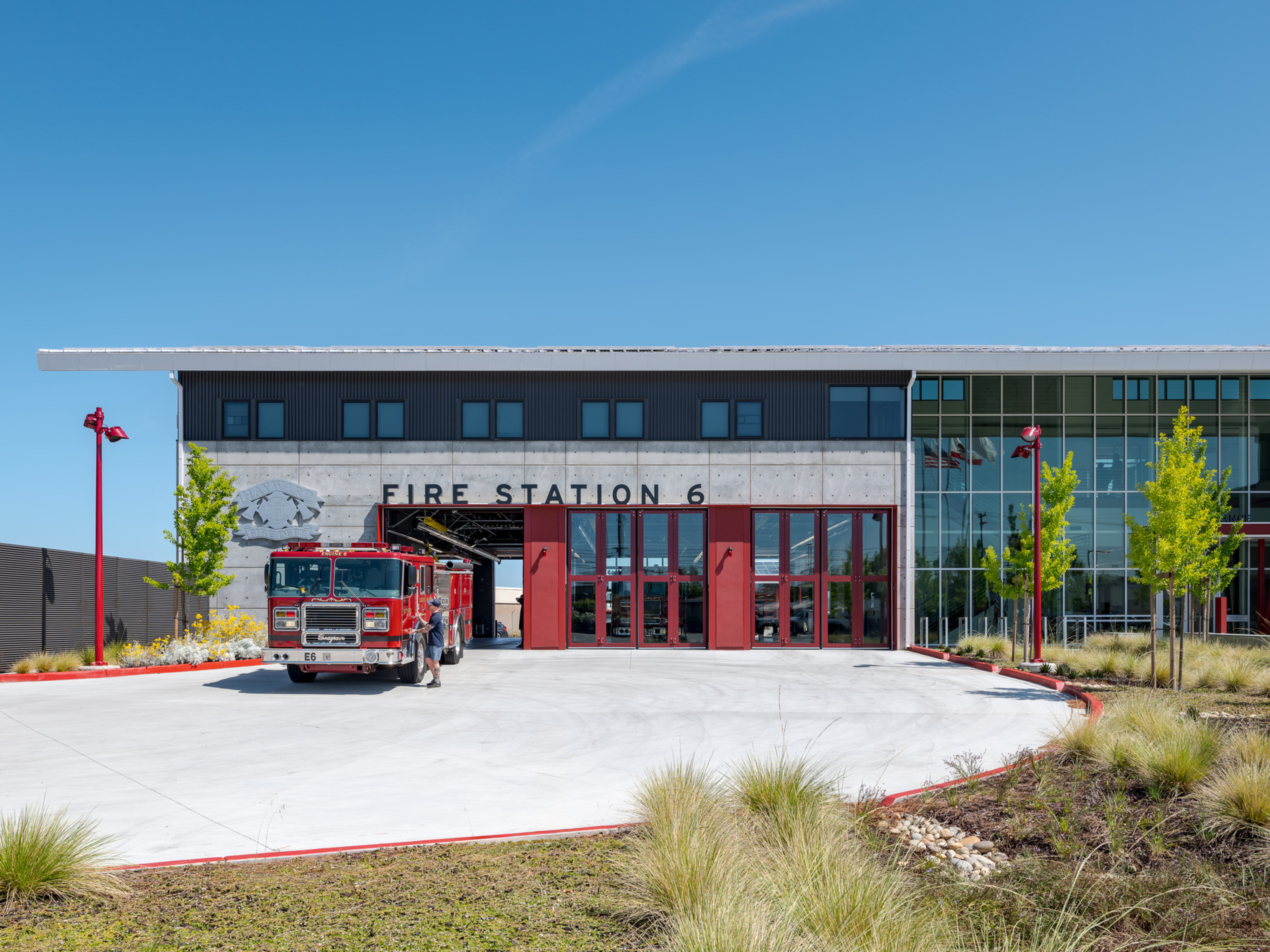 Front entrance to a fire station; modern sleek design with floor to ceiling windows
