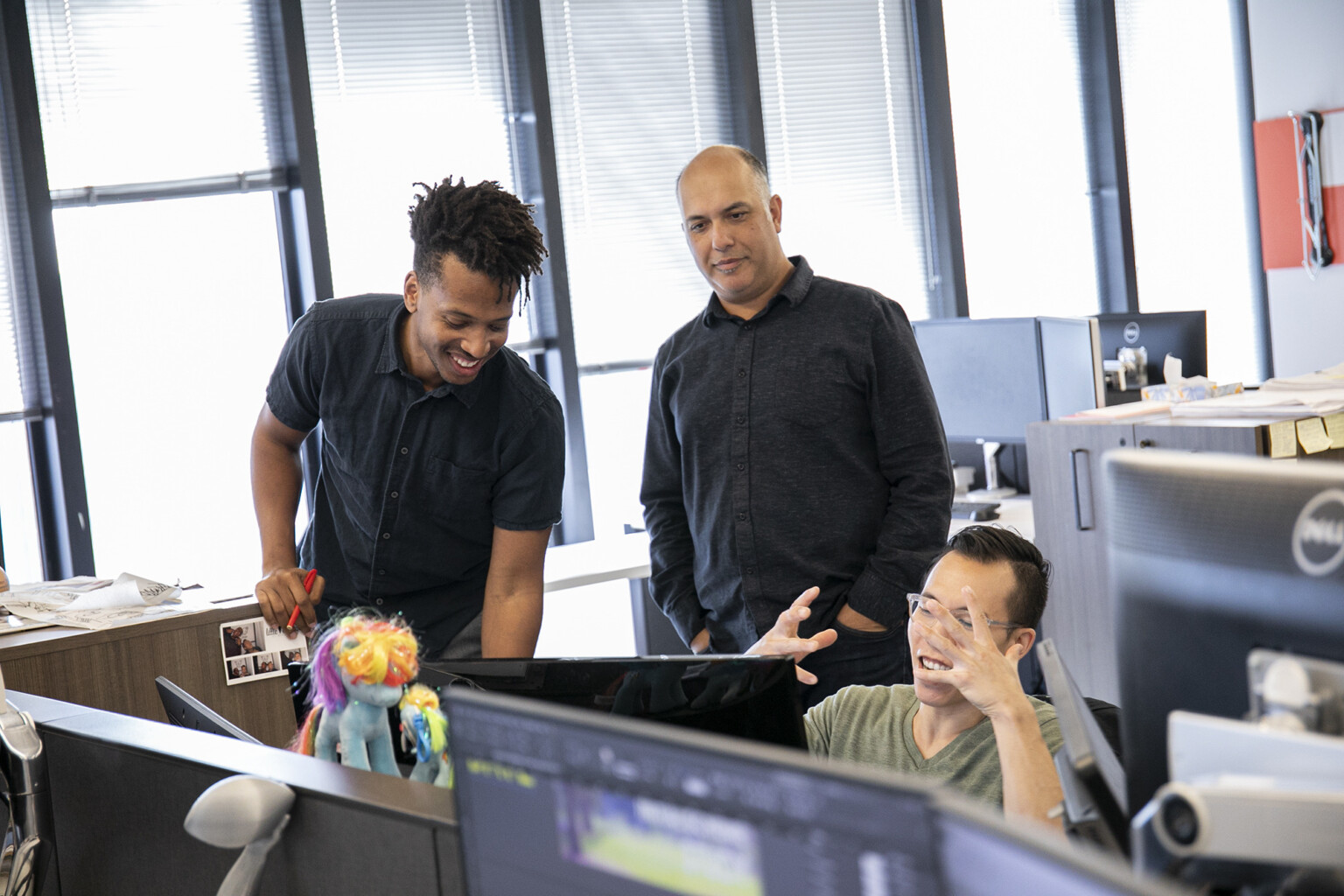 happy Black intern expressing insights with his team members