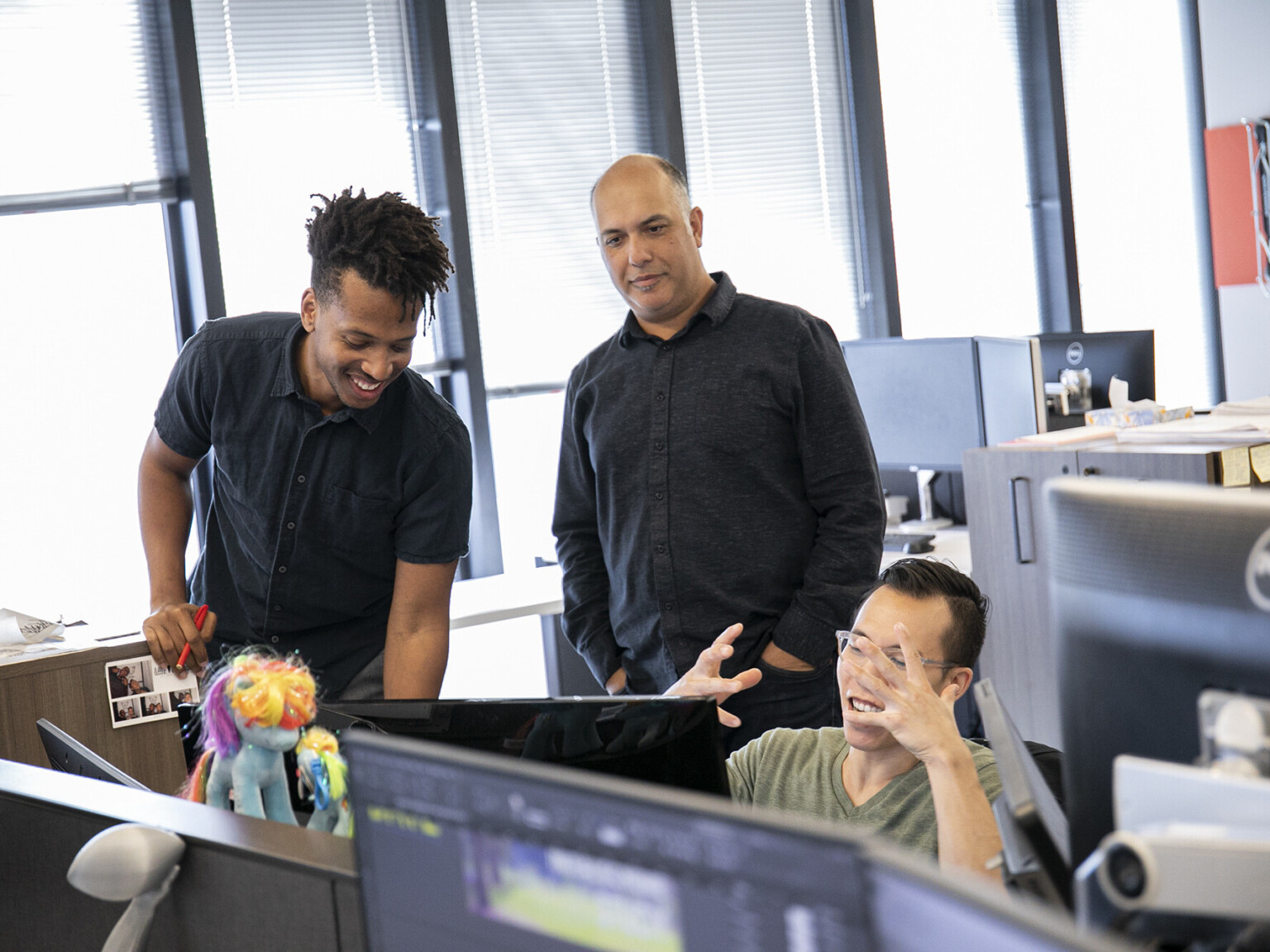 happy Black intern expressing insights with his team members