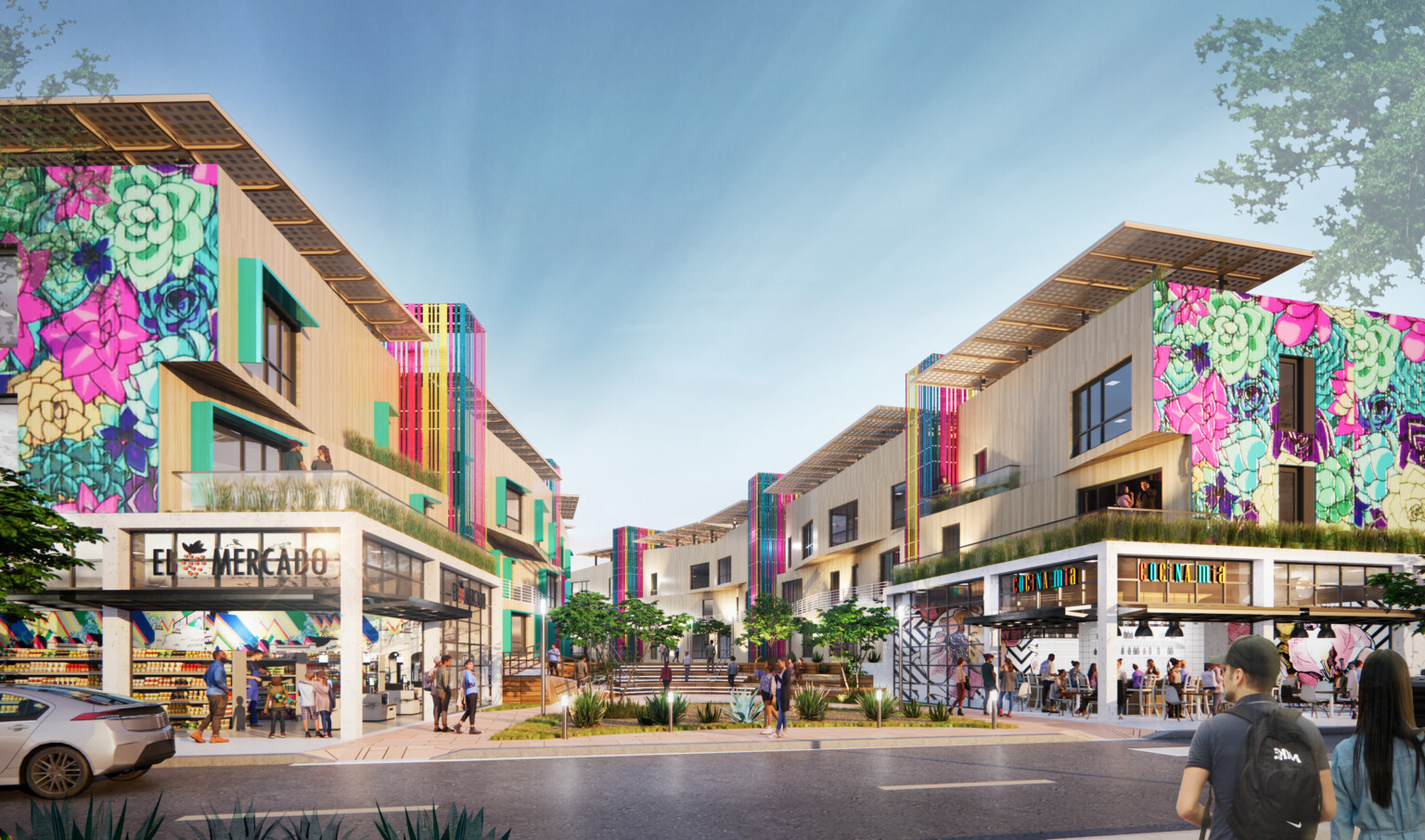 Semillas y Raices mixed use housing development entrance with shops on 1st level, apartments above on either side of walkway Semillas y Raices mixed use housing development entrance with shops on 1st level, apartments above on either side of walkway