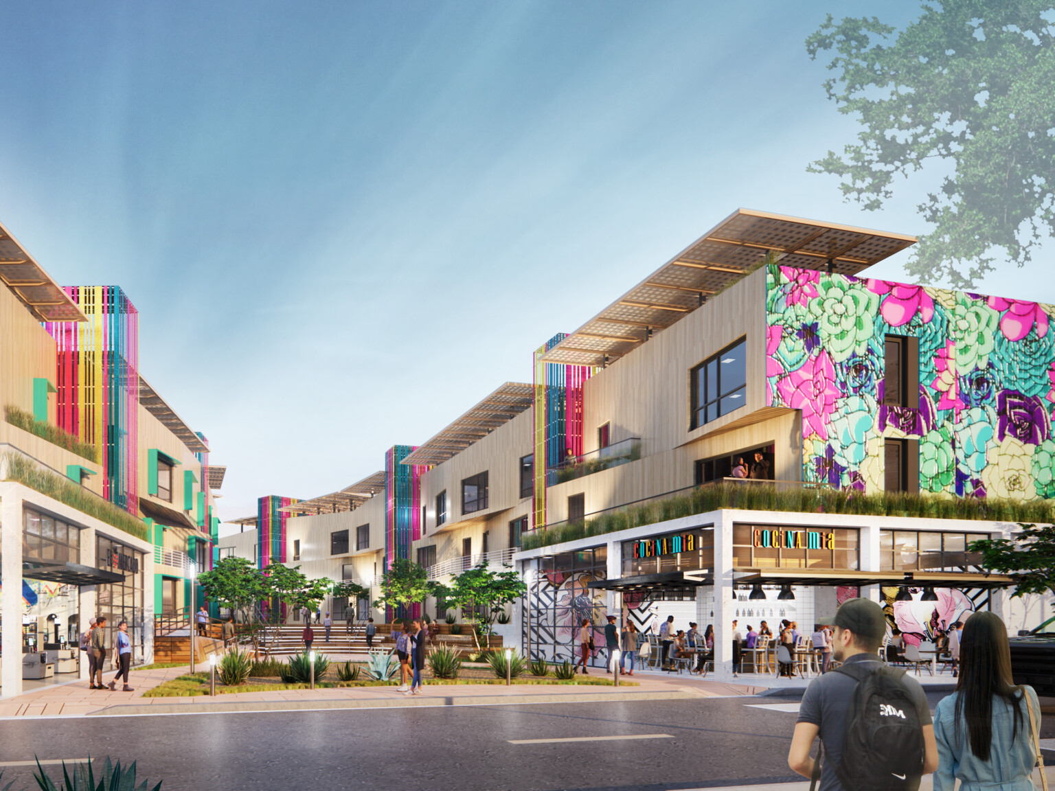 Semillas y Raices mixed use housing development entrance with shops on 1st level, apartments above on either side of walkway