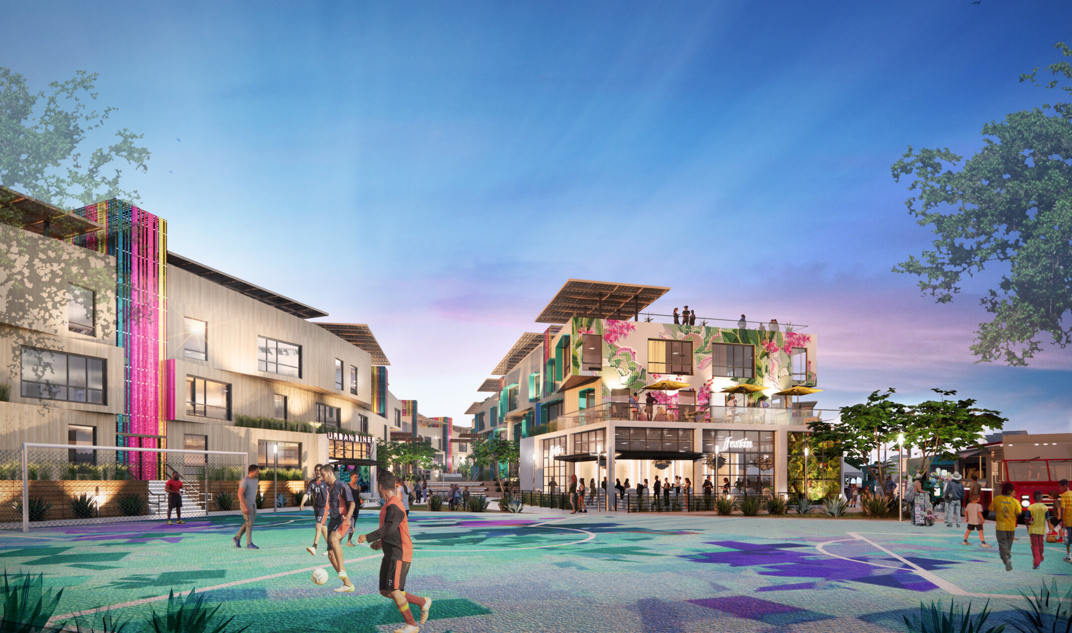 Community soccer field in front of 3 story mixed use buildings with store fronts, apartments, roof patios. Food trucks right