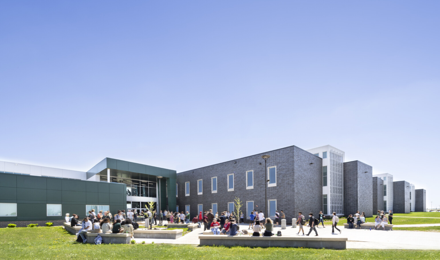 Exterior courtyard of Sioux Falls' Jefferson High School with wrapped facade square entry Exterior courtyard of Sioux Falls' Jefferson High School with wrapped facade square entry