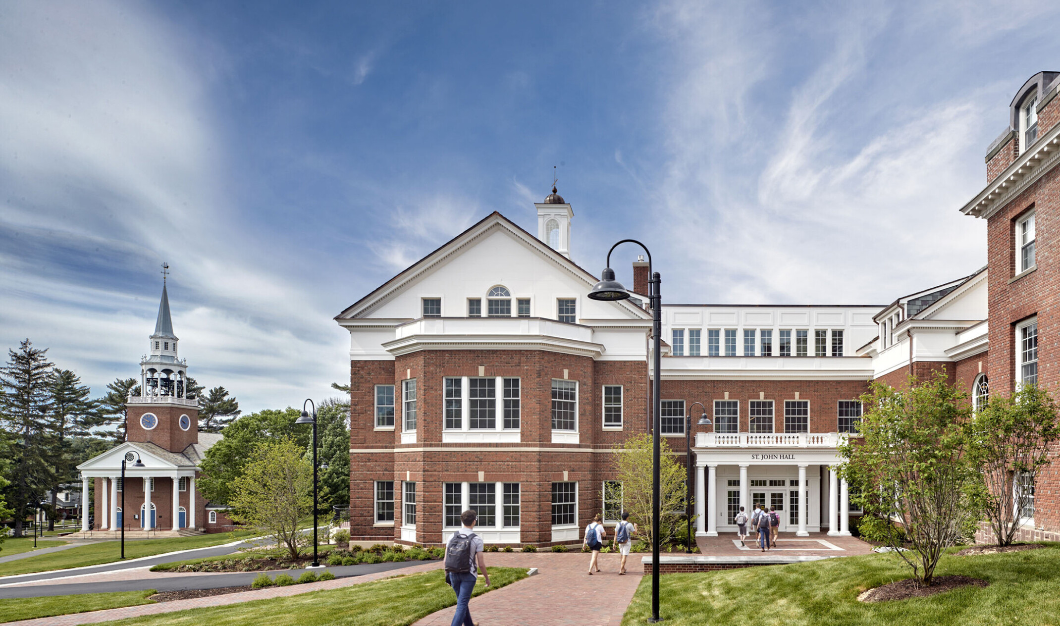 Choate Rosemary Hall, a neo-colonial red brick three-story building with entryway facing green lawn. Sign reads St. John Hall