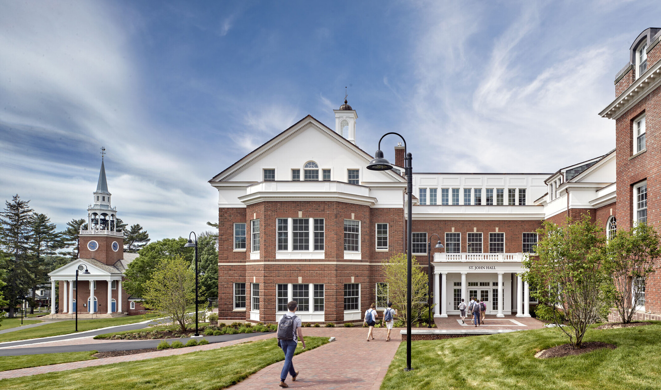 Choate Rosemary Hall, a neo-colonial red brick three-story building with entryway facing green lawn. Sign reads St. John Hall