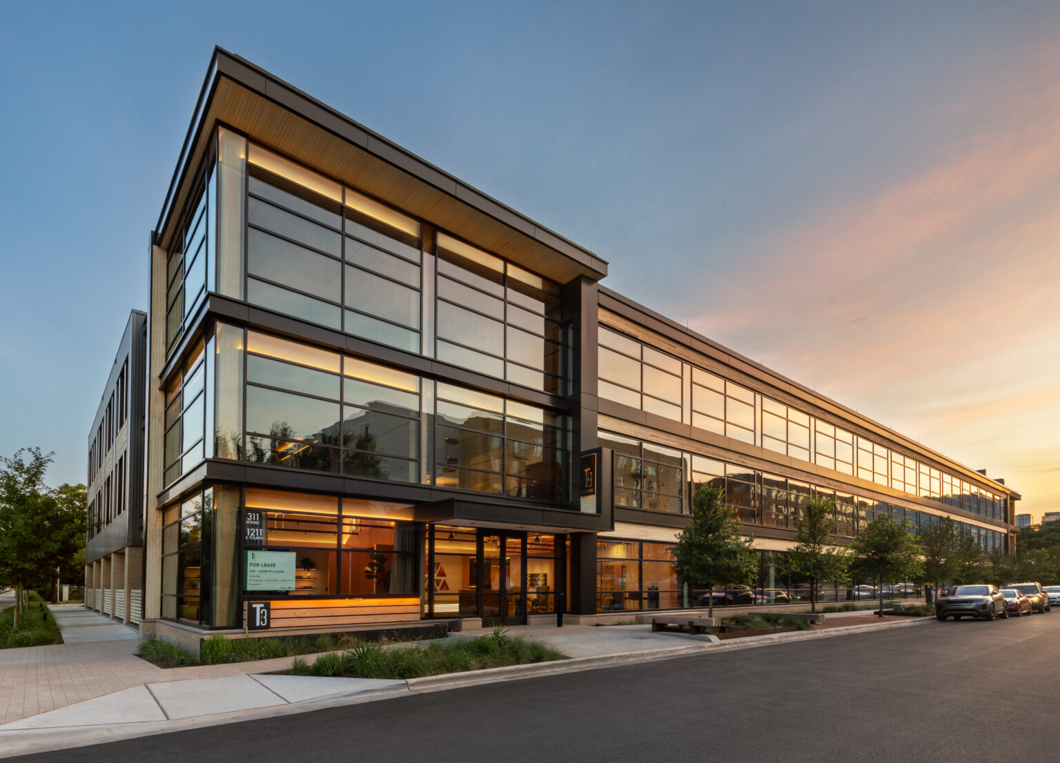 Mass timber midrise building with exposed wood, dark steel and reflective windows, t3 construction, t3 partners, t3 design