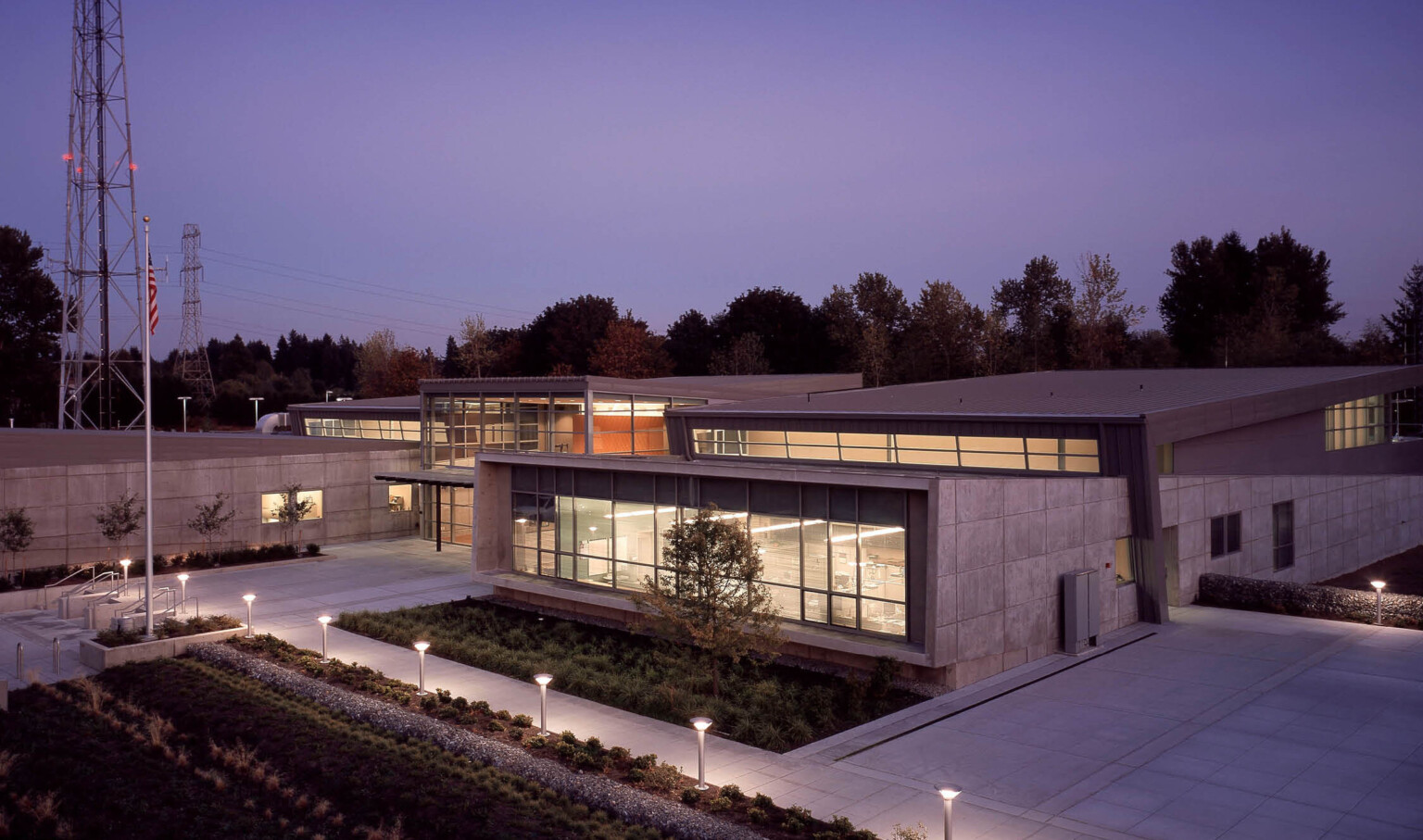 evening view of a communications and emergency center in Washington. Brutalism concrete façade is juxtaposed with modern glass walls. evening view of a communications and emergency center in Washington. Brutalism concrete façade is juxtaposed with modern glass walls.
