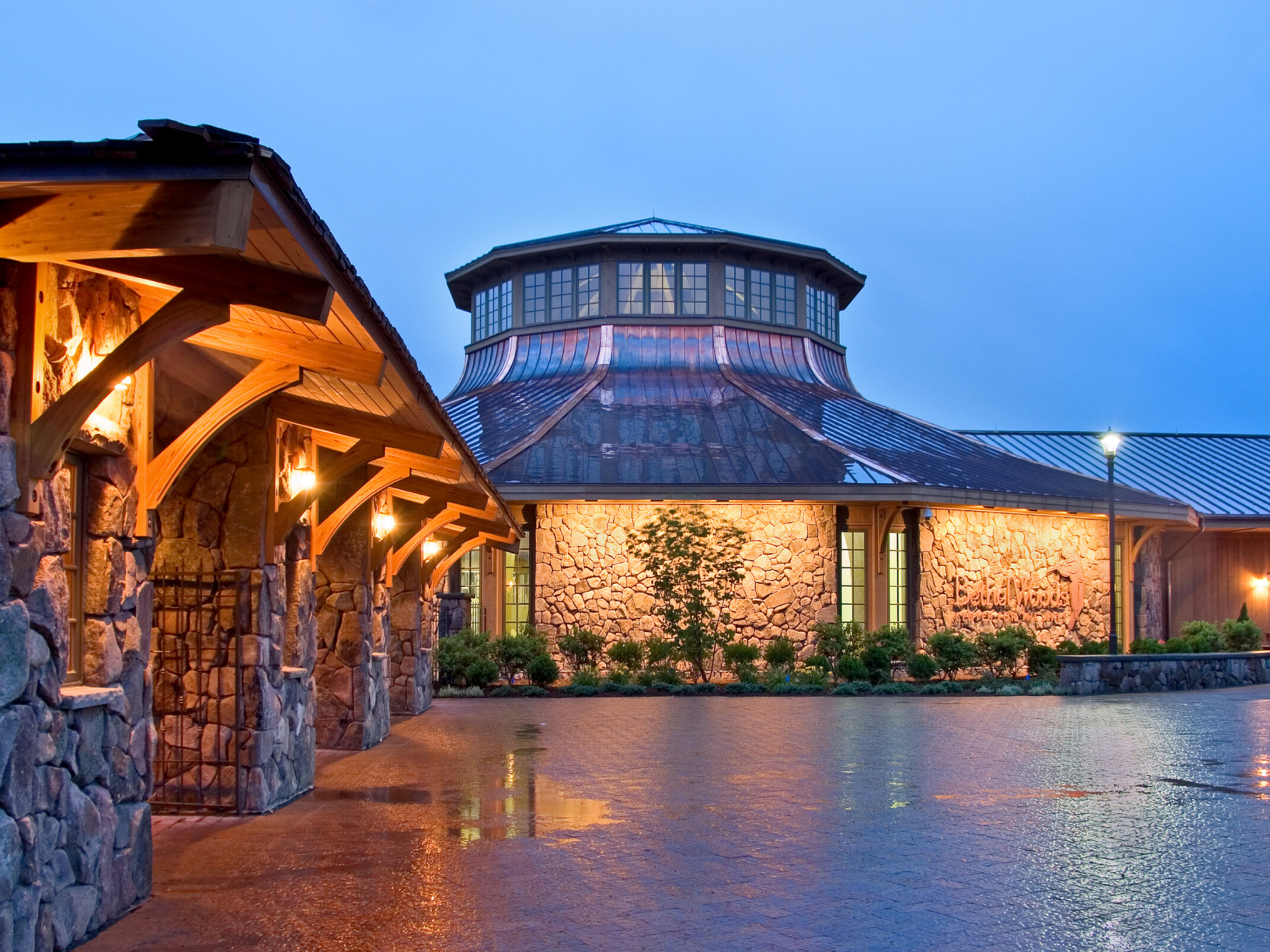 performing arts facility exterior central rounded dome with natural stone detail