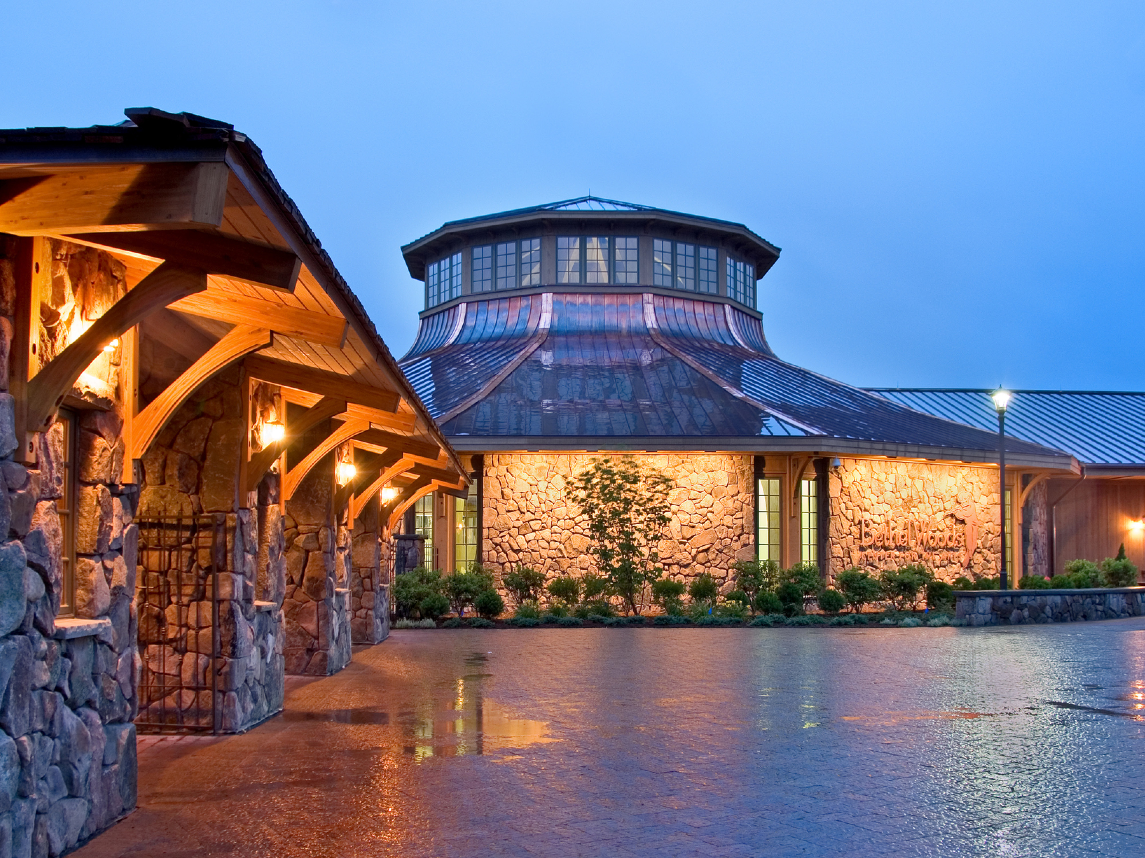 performing arts facility exterior central rounded dome with natural stone detail