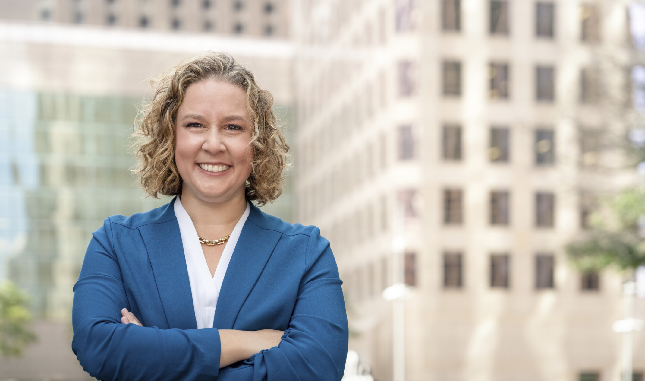 DLR Group Principal Emily Winters in a white blouse and blue jacket