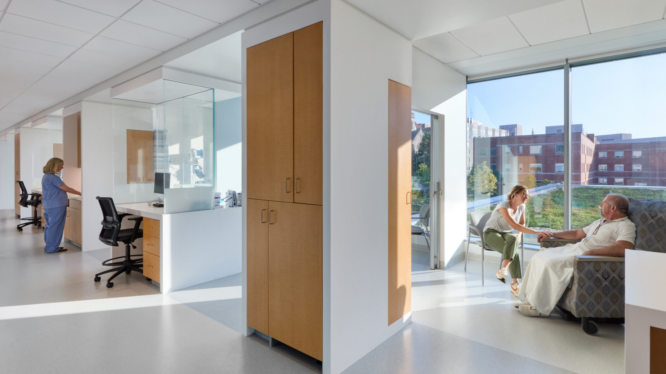 cancer care patient area with daylight streaming in, private rooms, and light colors