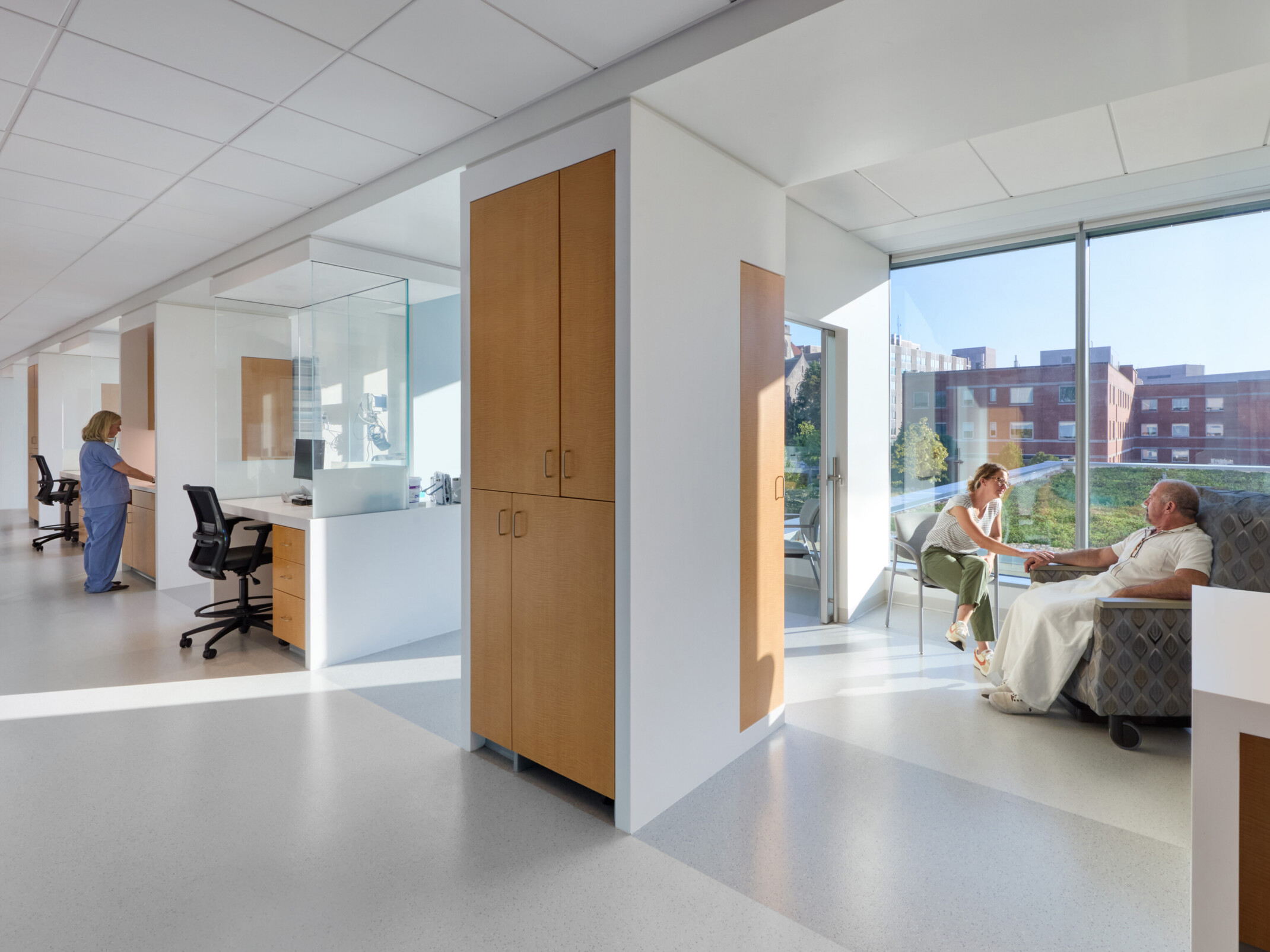 cancer care patient area with daylight streaming in, private rooms, and light colors