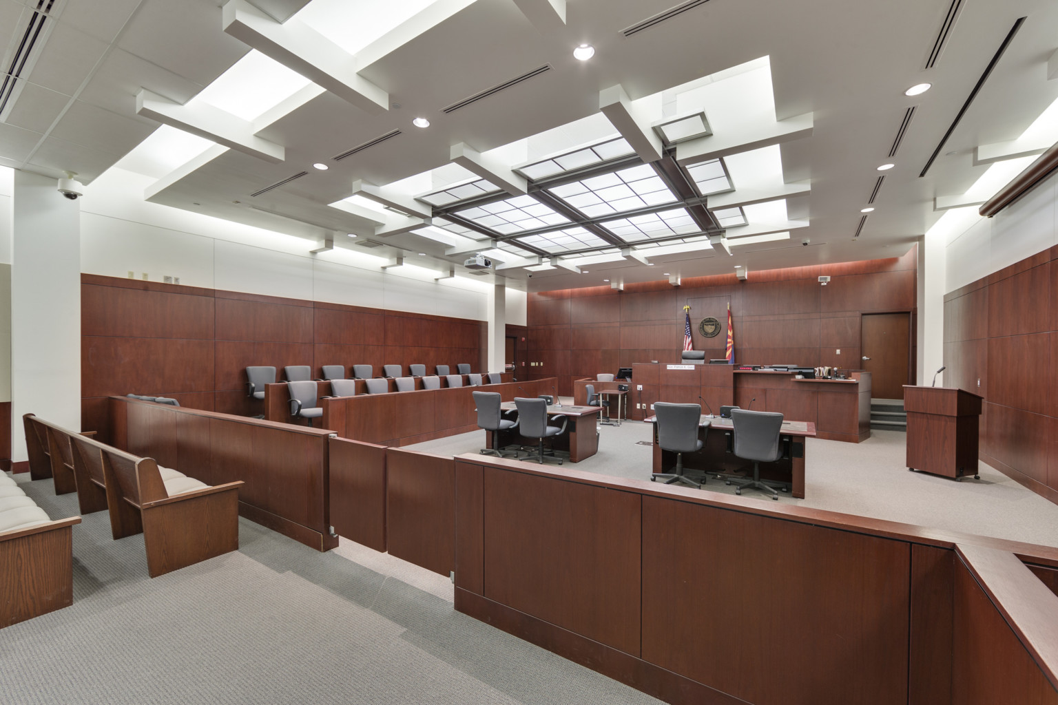 Pinal County courtroom with wooden features and grey seats looking toward judge seat