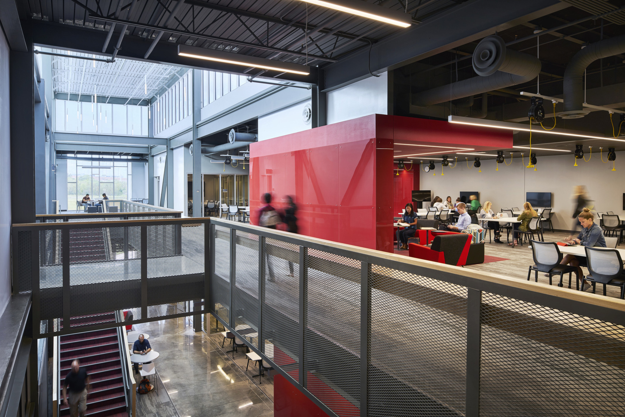 second floor collaboration learning area with breakout nodes and a large red architectural divider at the missouri innovation campus