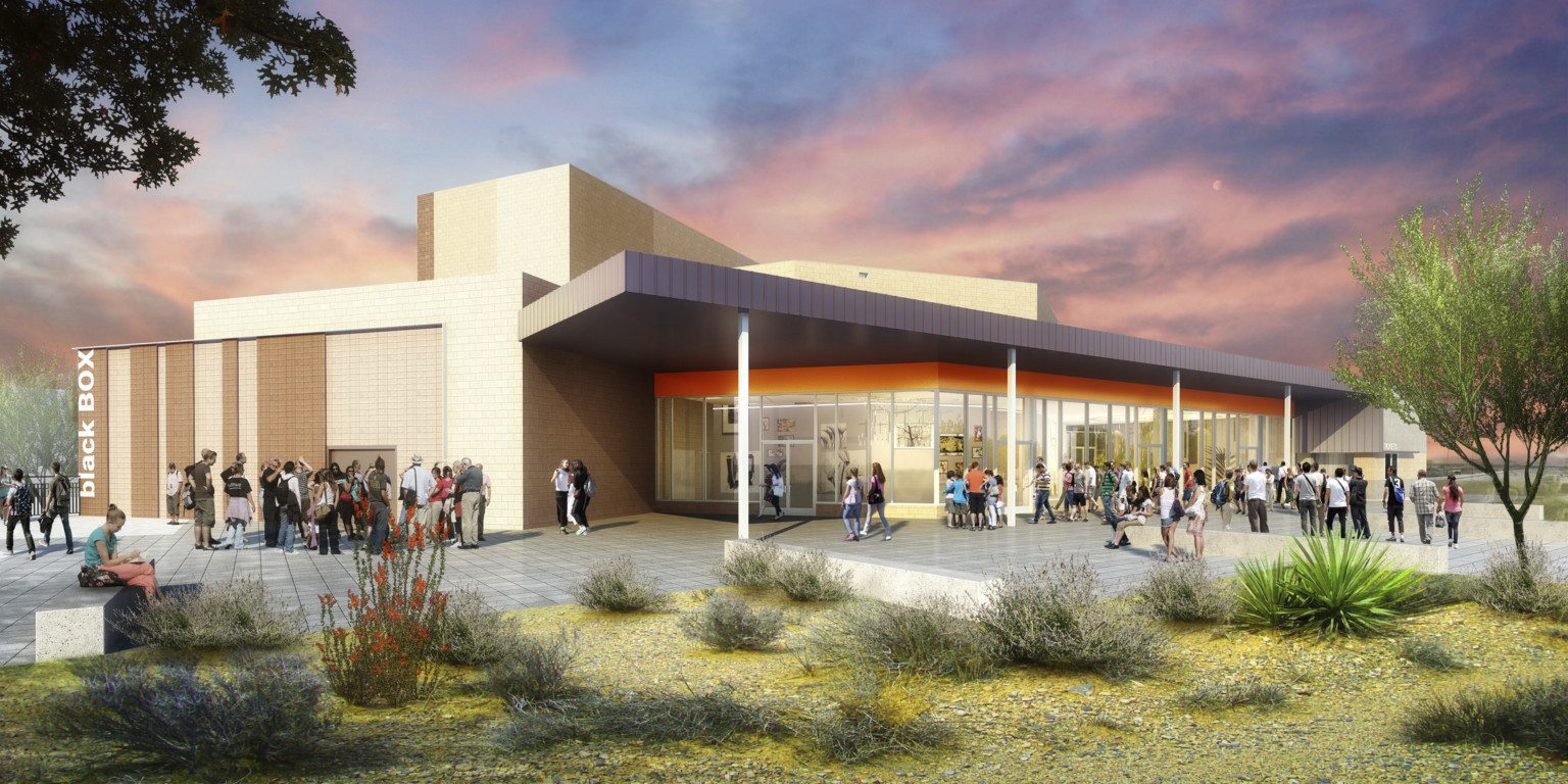 Exterior view of J.O. Combs High School Auditorium, orange accent over floor to ceiling window entry of beige building