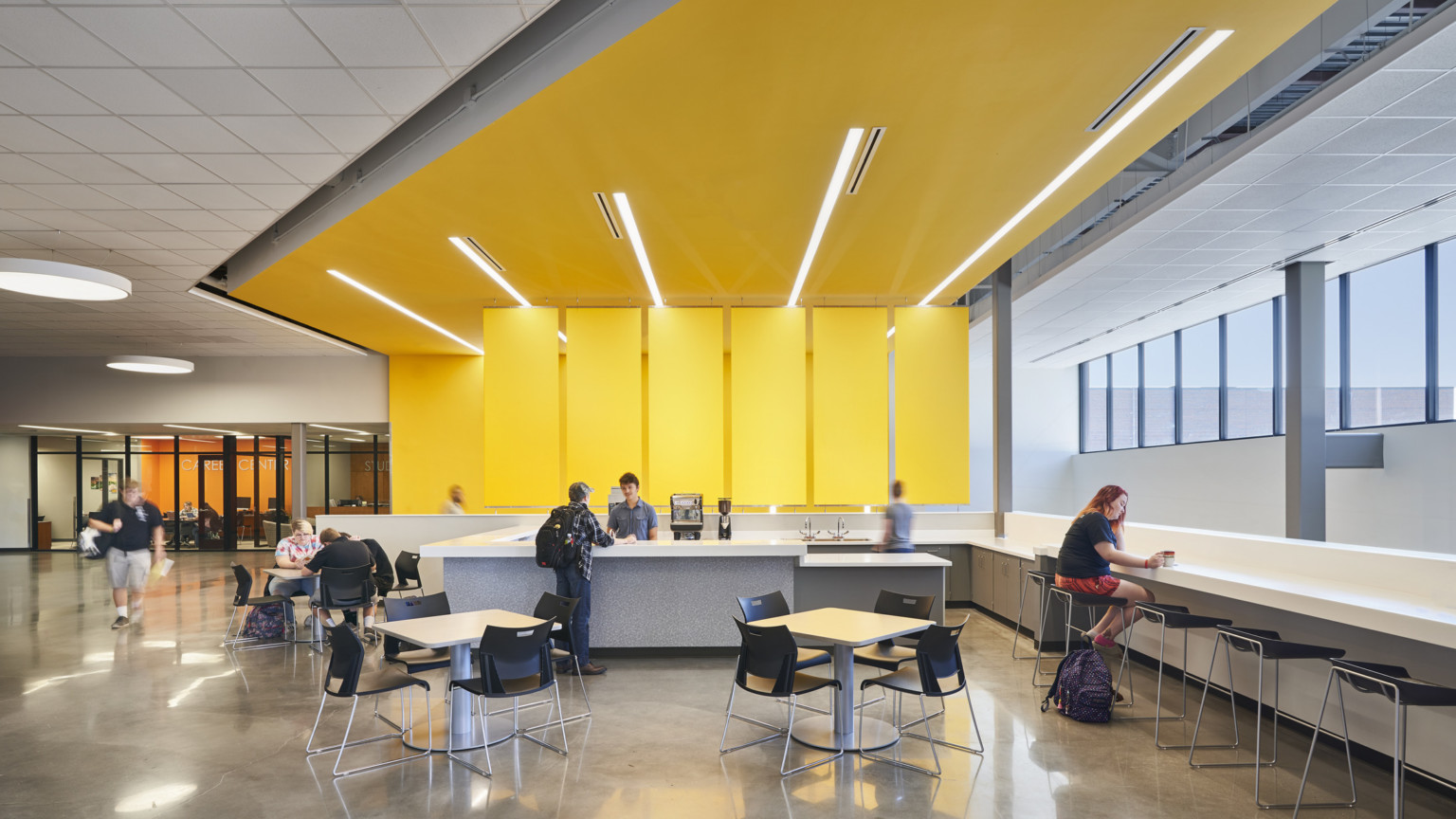 21st century learning environment activating community space for students with study counter and yellow design feature covering the wall and ceiling at salina south high school 21st century learning environment activating community space for students with study counter and yellow design feature covering the wall and ceiling at salina south high school