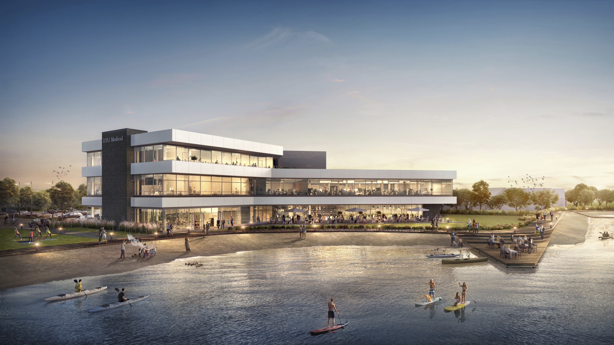 RTG Medical Headquarters viewed from across the water. A 3 story building with large windows and waterfront patio and dock RTG Medical Headquarters viewed from across the water. A 3 story building with large windows and waterfront patio and dock