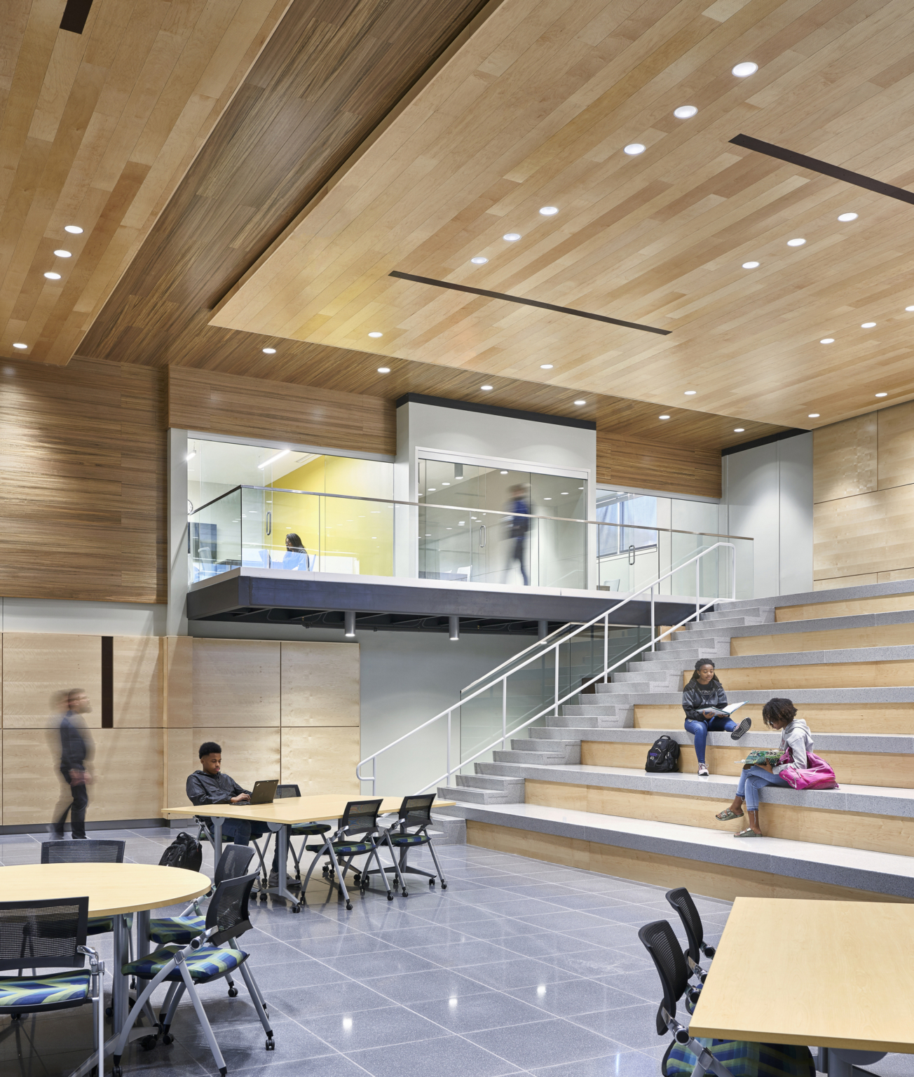 Open space with tables and wooden rows of seating at Topeka Center for Advanced Learning & Careers Open space with tables and wooden rows of seating at Topeka Center for Advanced Learning & Careers