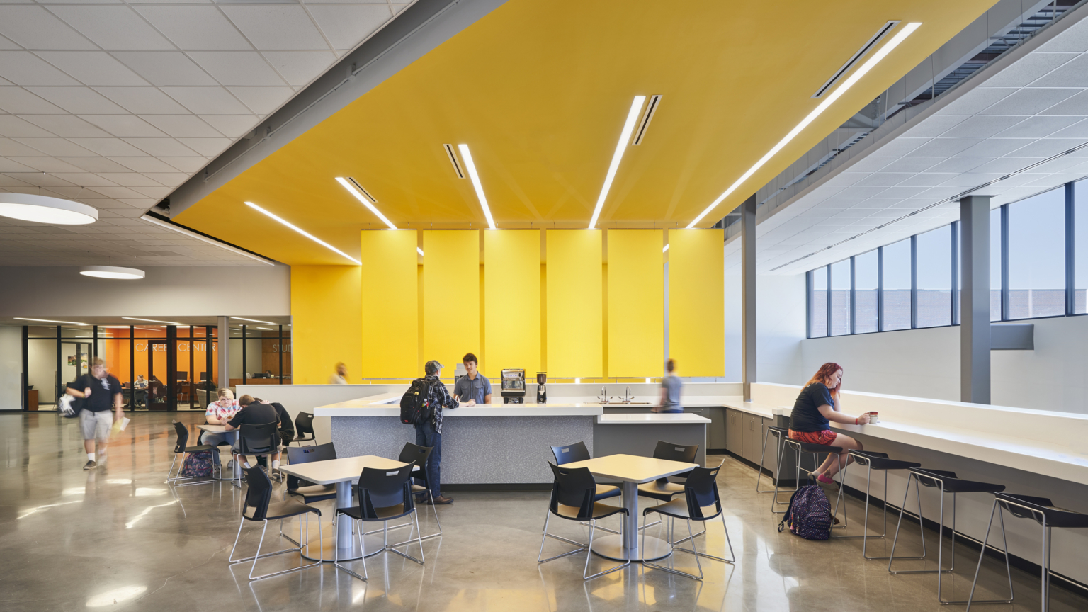 21st century learning environment activating community space for students with study counter and yellow design feature covering the wall and ceiling at salina south high school 21st century learning environment activating community space for students with study counter and yellow design feature covering the wall and ceiling at salina south high school