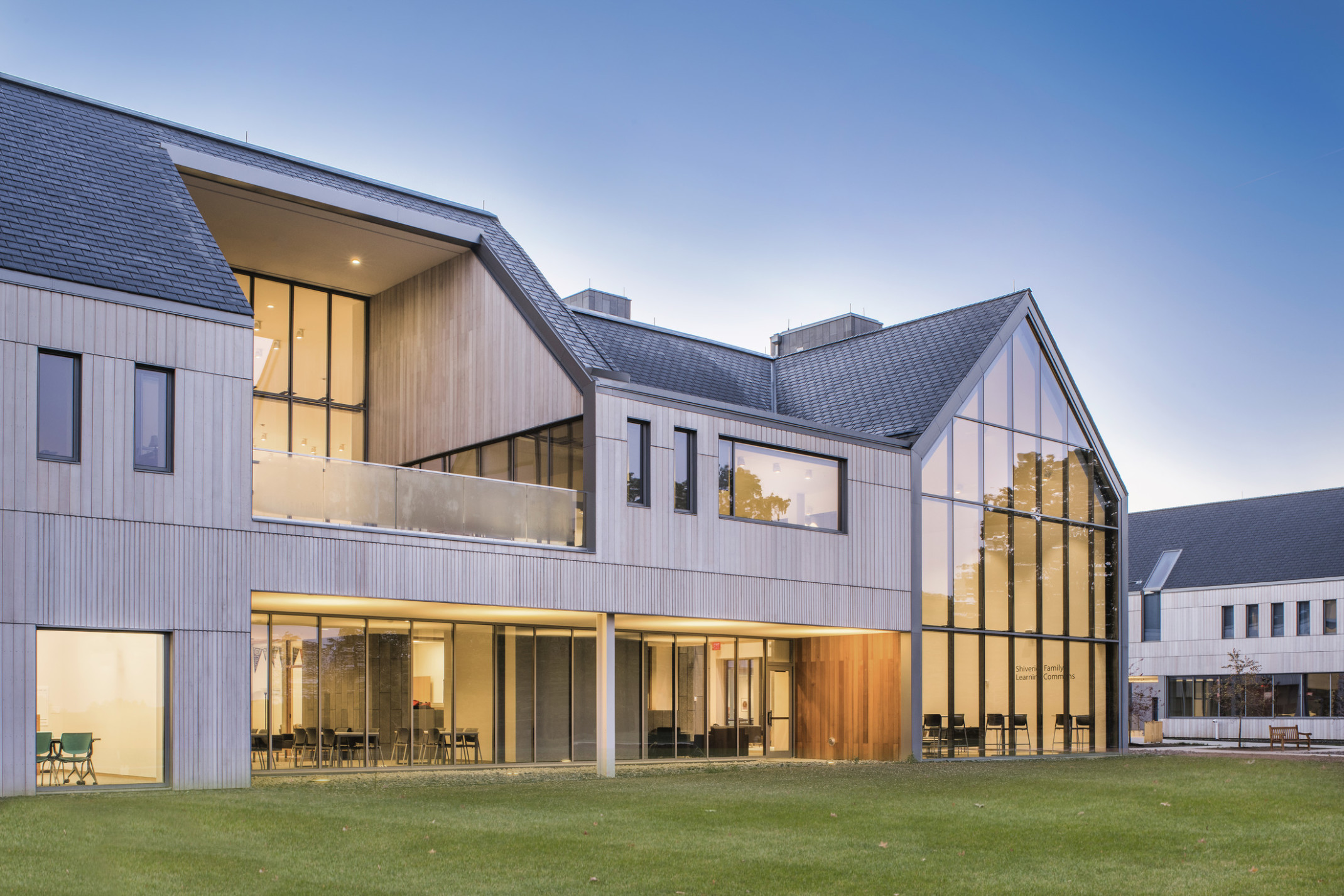 Hawken School's Stirn Hall exterior. A wood panel building with angled dark shingle roof. Pointed triple height windows right Hawken School's Stirn Hall exterior. A wood panel building with angled dark shingle roof. Pointed triple height windows right
