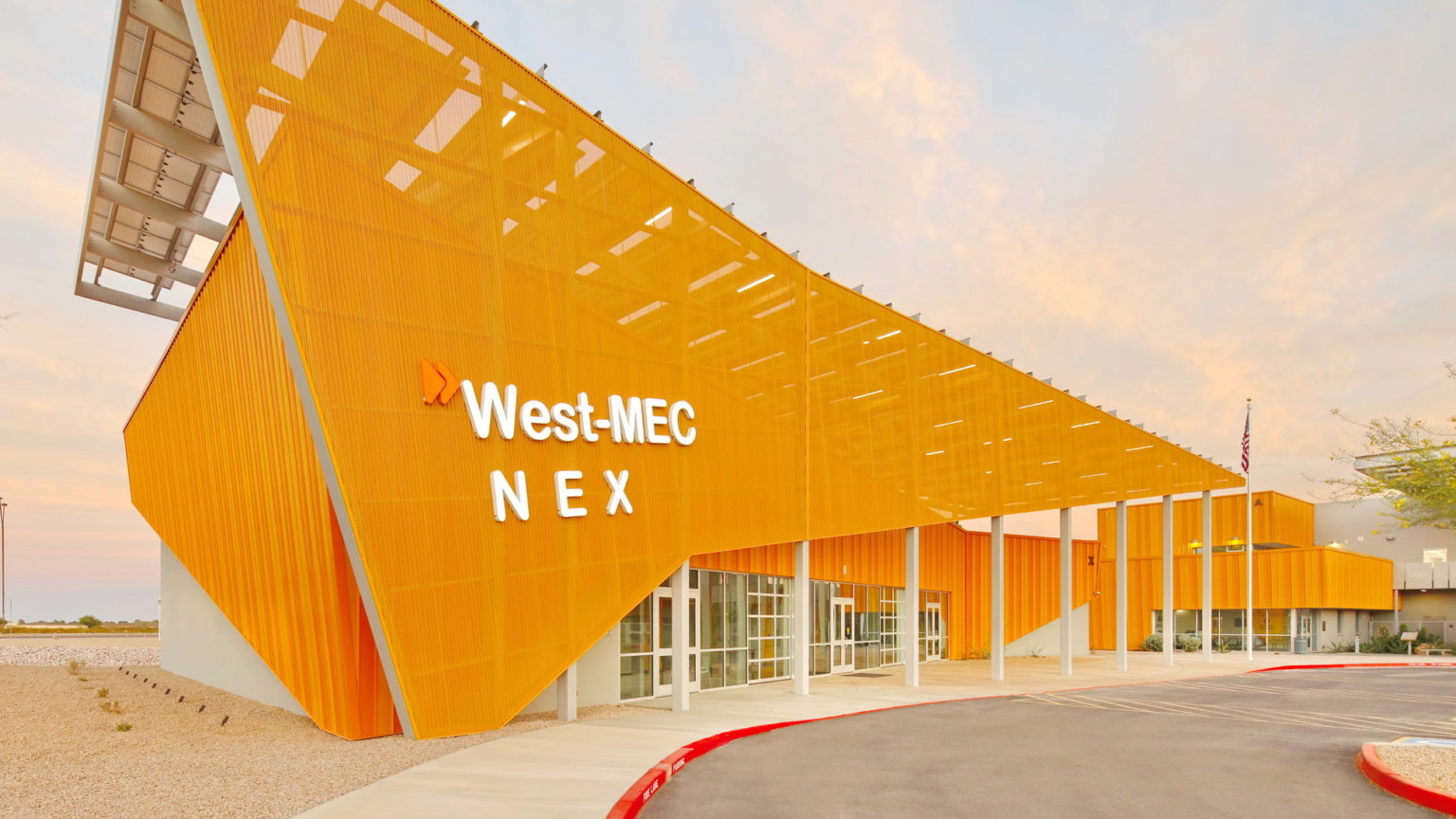 bright orange building erected at a deep angle with the title West Mec NEX building bright orange building erected at a deep angle with the title West Mec NEX building