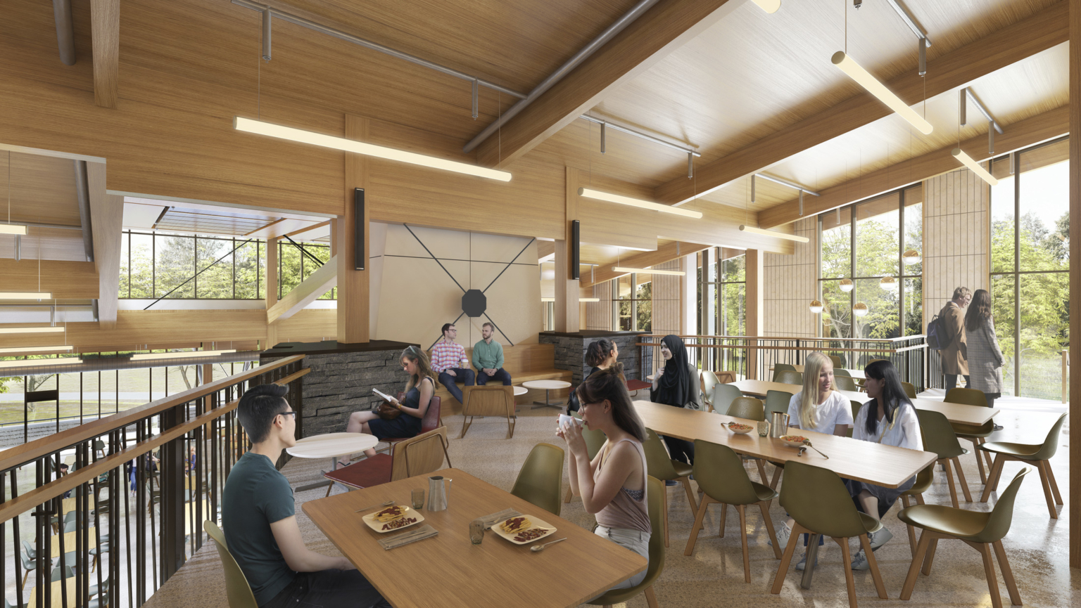 Upper dining area with stone accent wall, wood ceilings, and beams. There is a black iron railing overlooking the main floor dining area at Swarthmore College Dining and Community Commons.