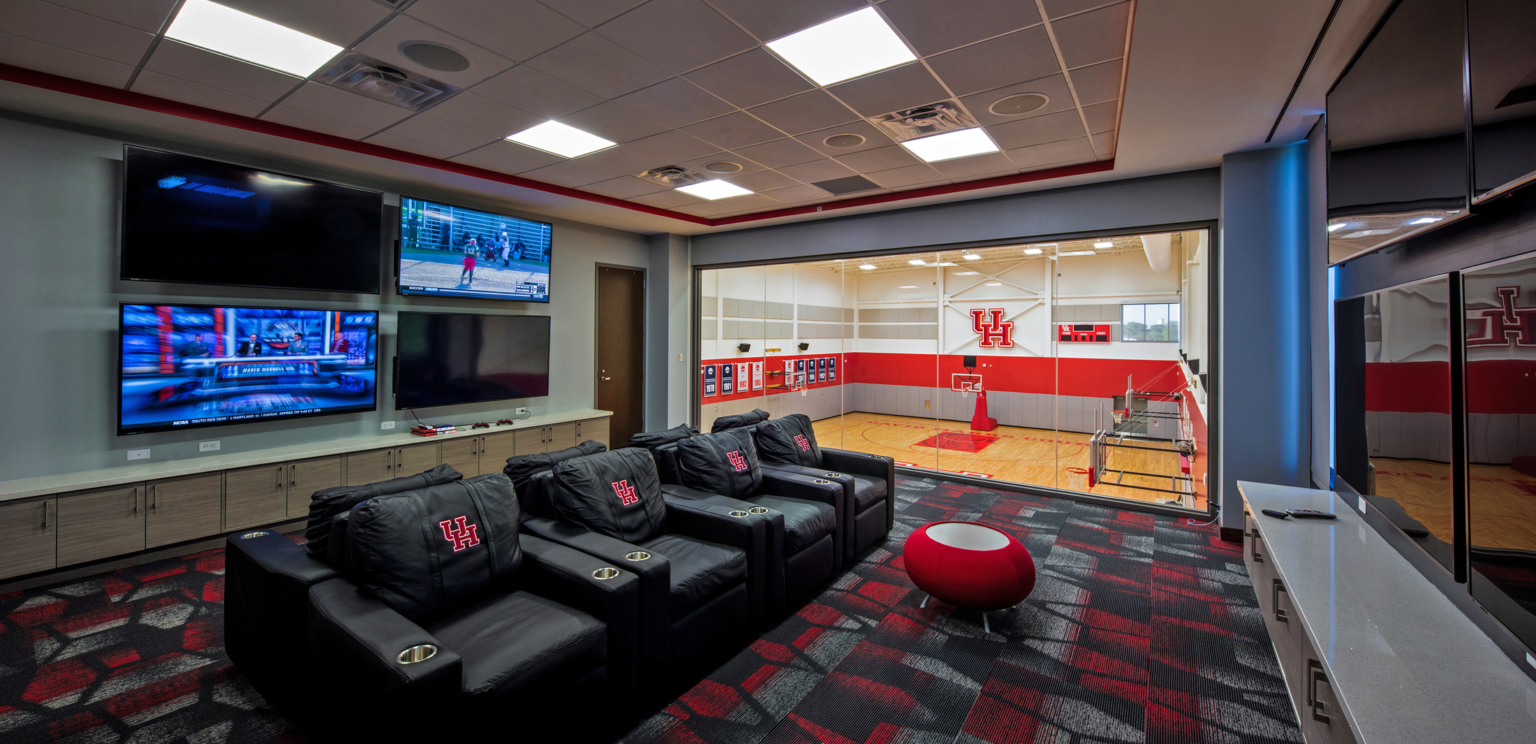 seating area with large tv screens overlooking basketball court at the University of Houston