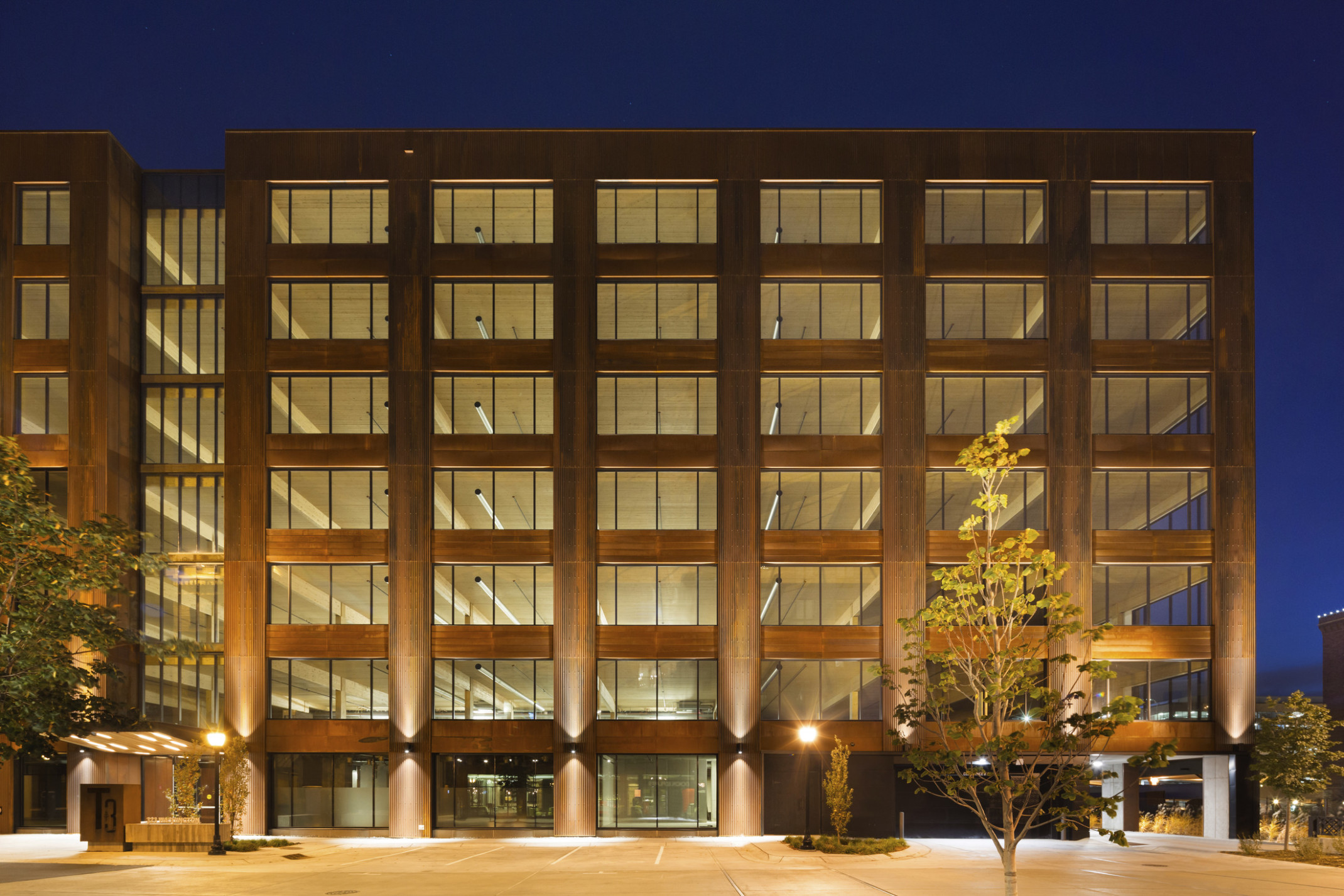 Hines T3 Partnership building in Minneapolis, a mass timber midrise building illuminated at night Hines T3 Partnership building in Minneapolis, a mass timber midrise building illuminated at night